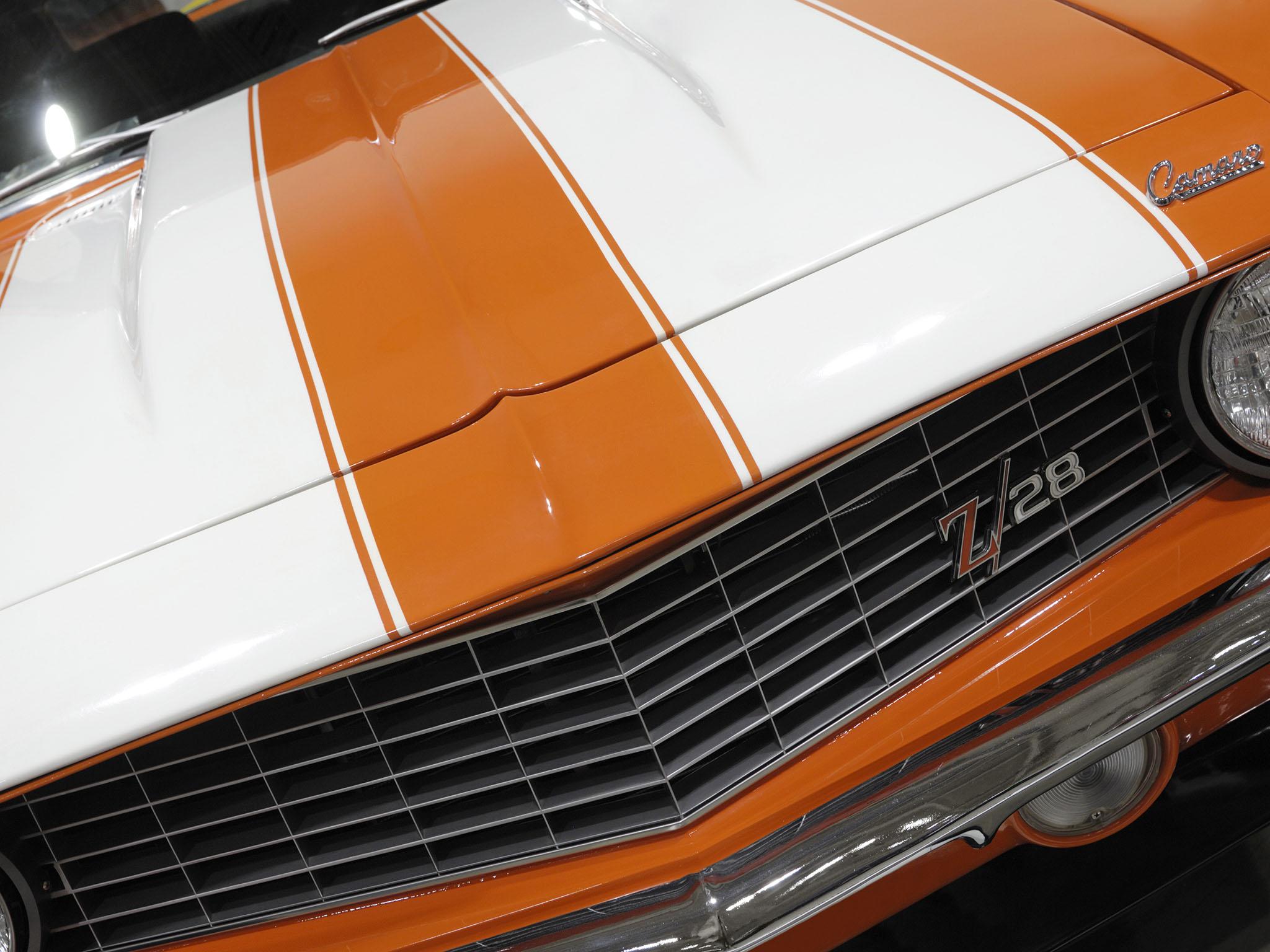 1969 Chevrolet Camaro Z28 retro sports car with white stripes over orange body