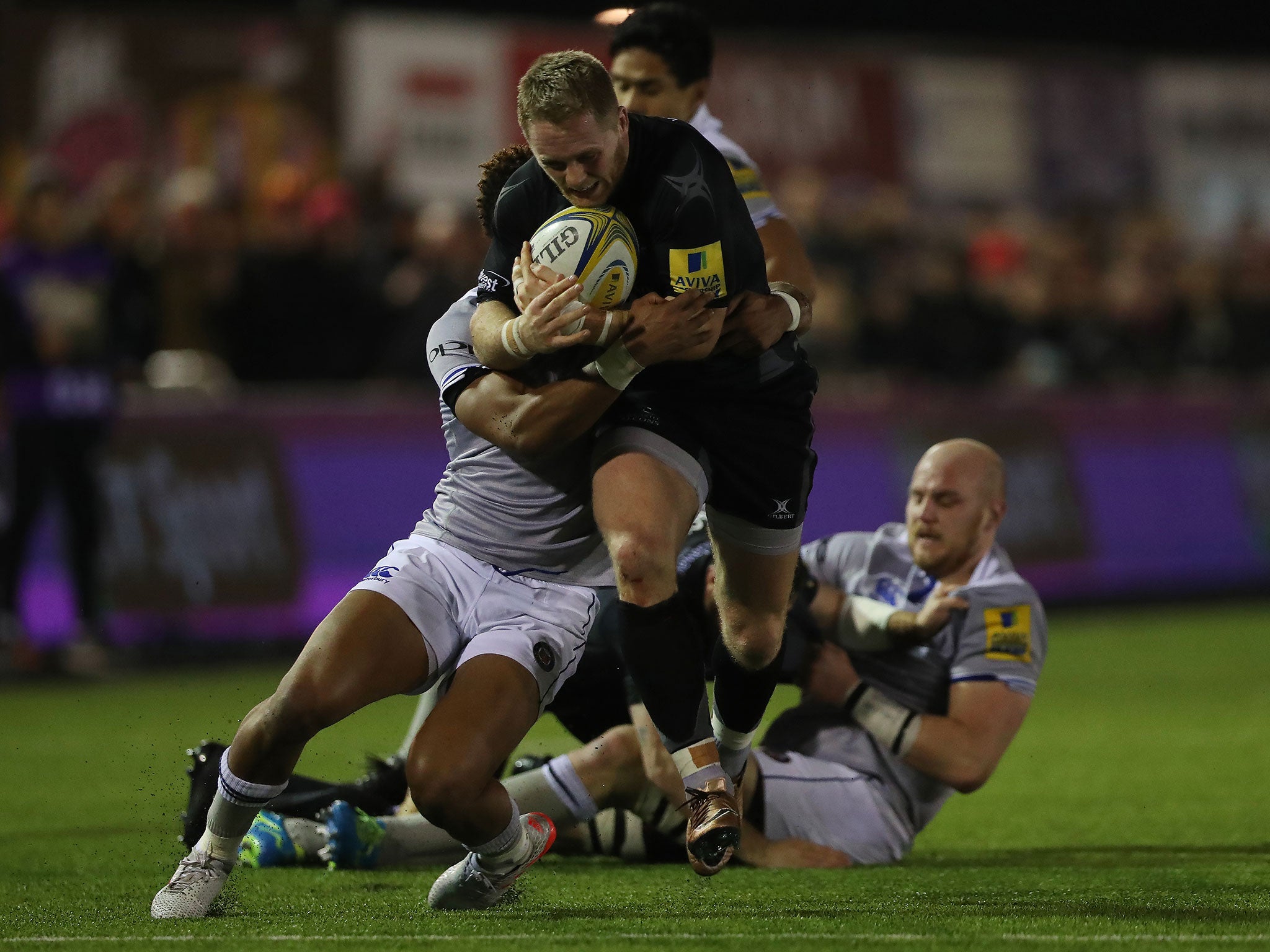 Alex Tait of Newcastle Falcons is brought down by Anthony Watson of Bath