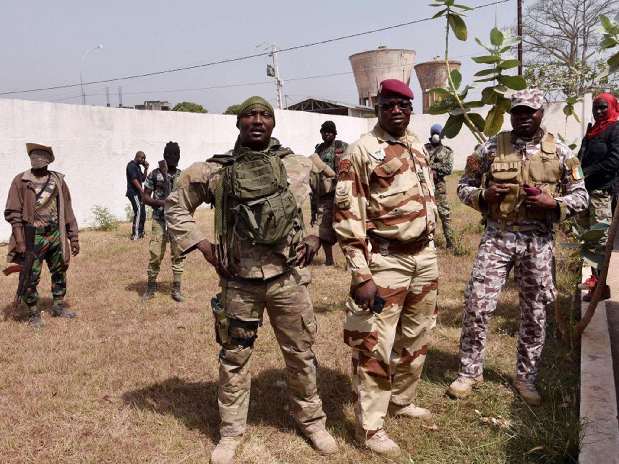 Lieutenant-colonel Issiaka Ouattara (centre), also known as Wattao, flanked by soldiers, arrives at the deputy prefect's residence in Bouake for talks with the deputy prefect and Defence Minister Alain-Richard Donwahi