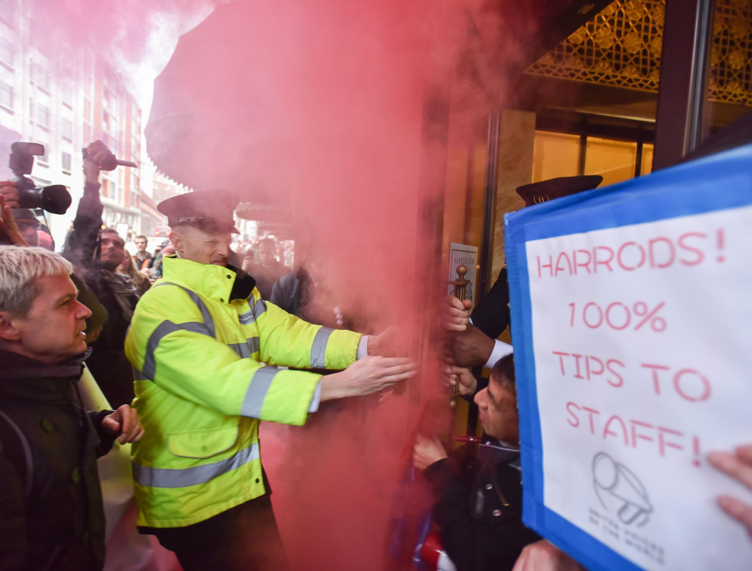 Protesters let off a smoke bomb outside Harrods department store in Knightsbridge