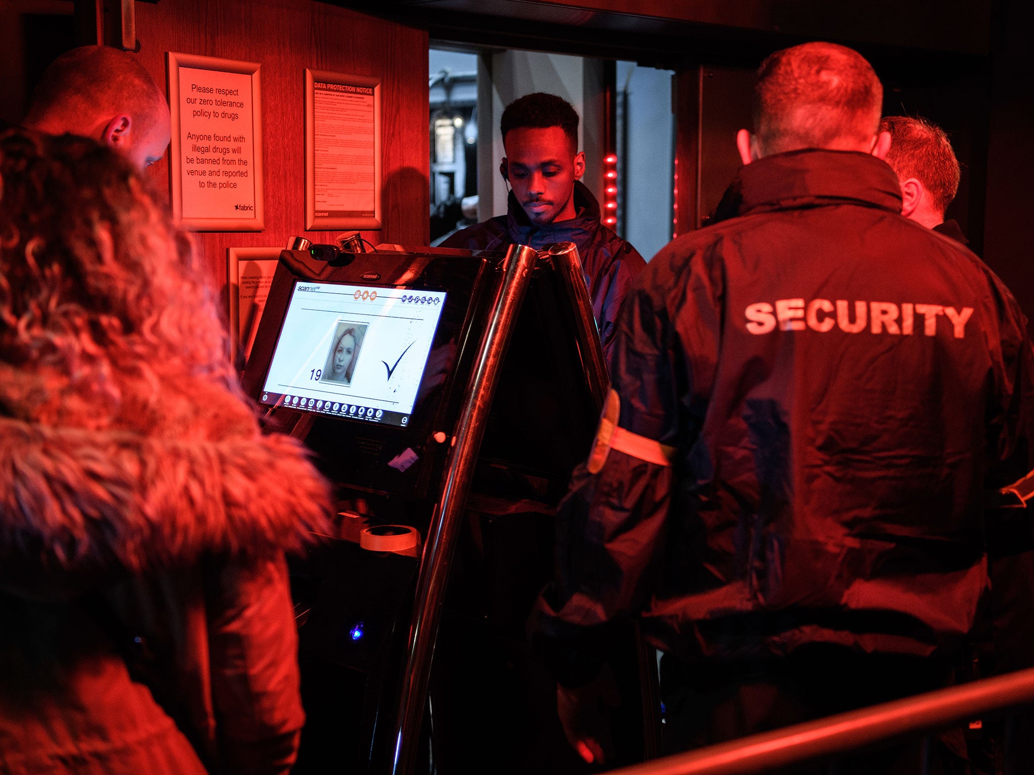 Guests have their identities checked as they arrive at the iconic Fabric nightclub as it re-opens its doors on January 6, 2017 in London