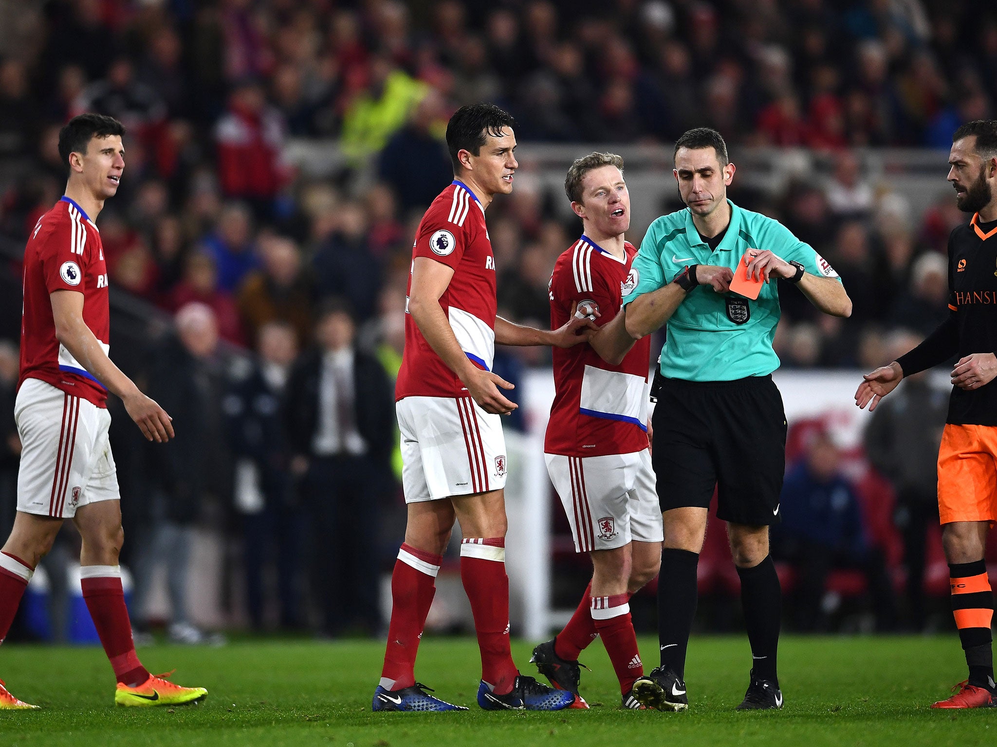 Daniel Ayala of Middlesbrough (L) reacts after being shown a red card by referee David Coote