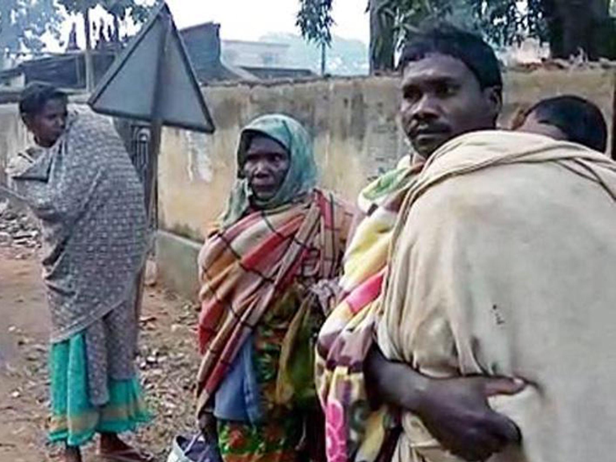 Gati Dhibar, right, had to carry his daughter many miles to his house after he was refused a hearse