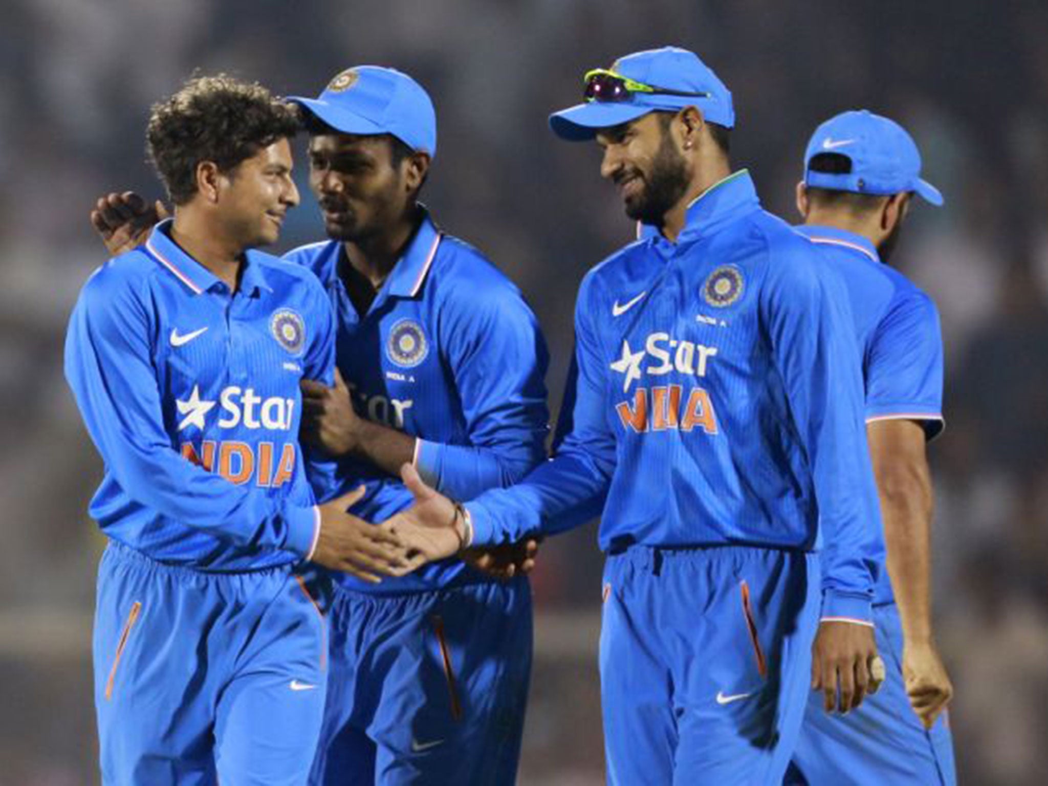 Kuldeep Yadav is congratulated after taking the wicket of England's Alex Hales