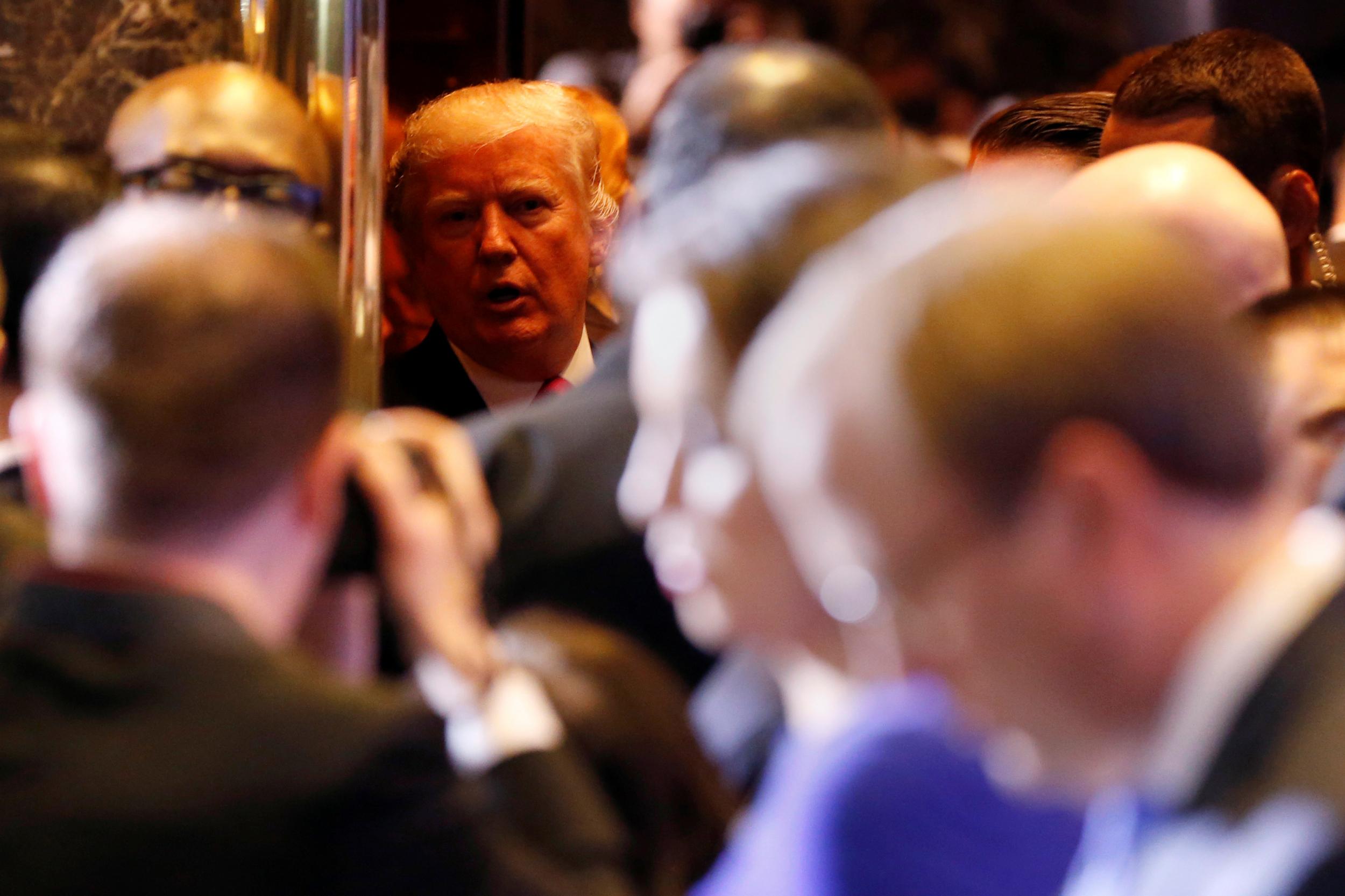 Donald Trump leaves a news conference in Trump Tower