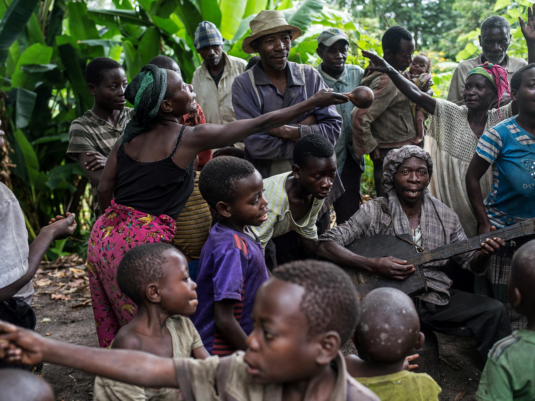 People sing and dance at the camp