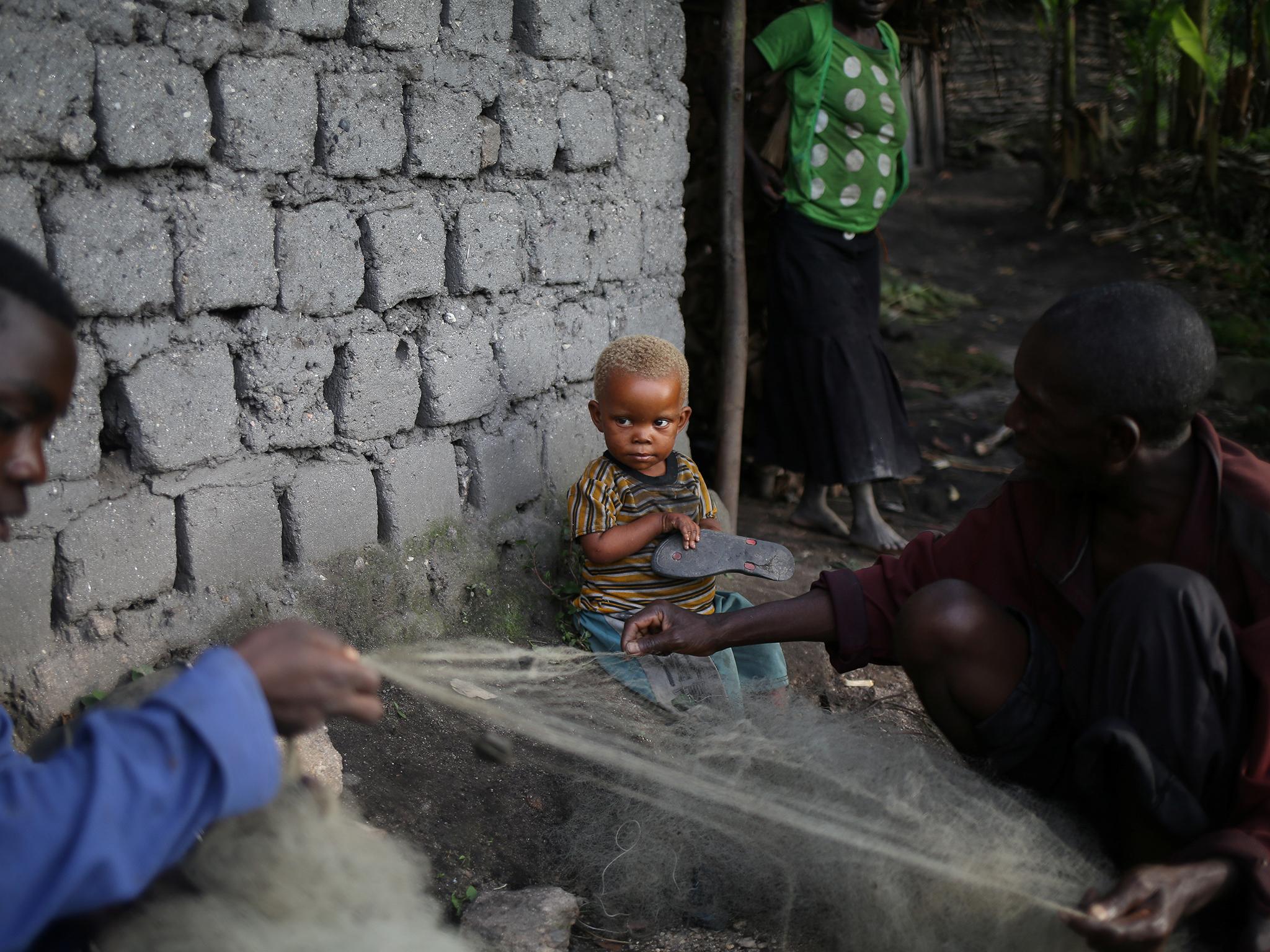 Men repair fishing nets at Kagorwa camp on Idjwi island