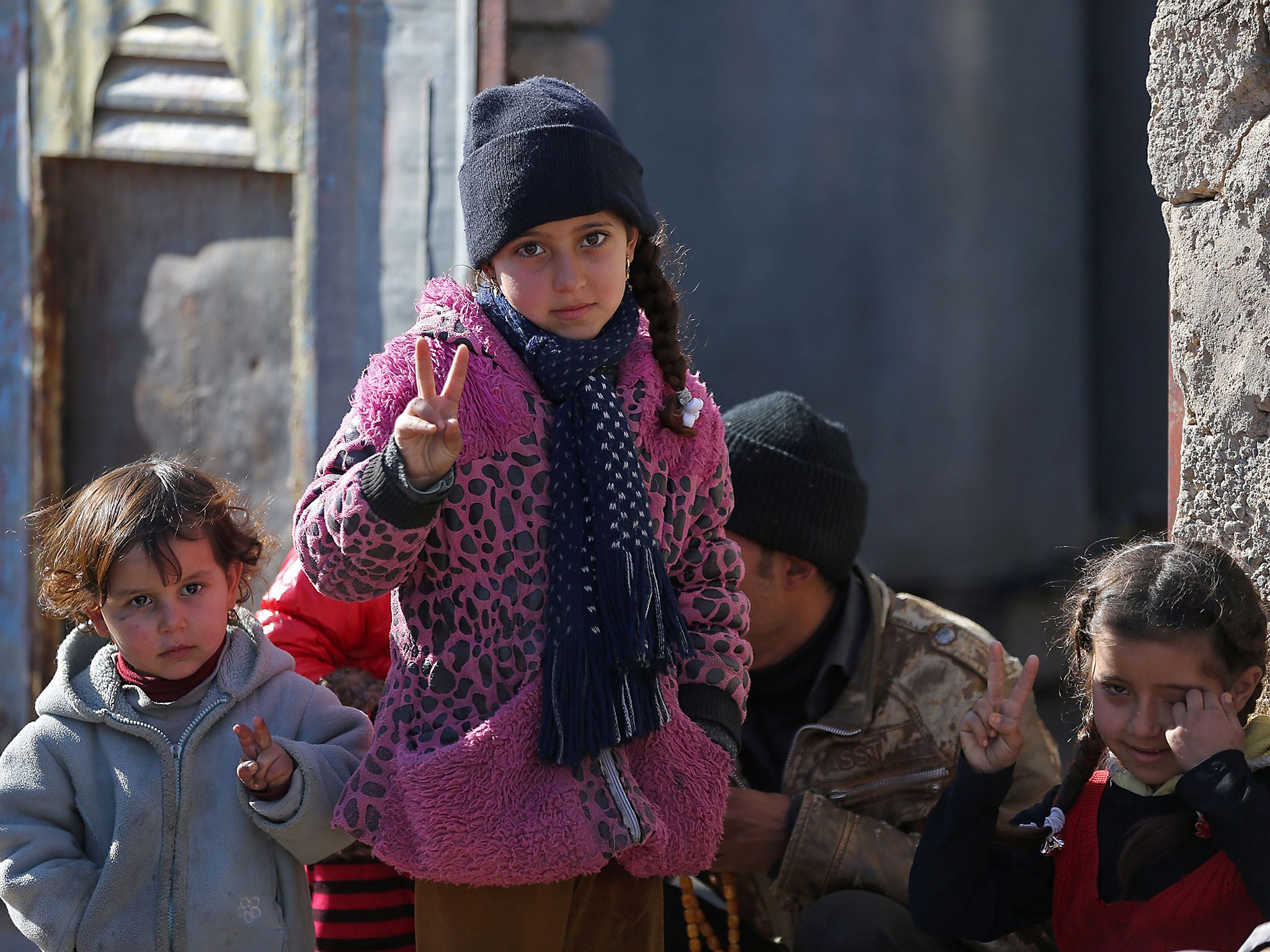 Iraqi children flash the sign for victory in the Al-Natsar neighbourhood in the eastern part of the embattled Iraqi city of Mosul