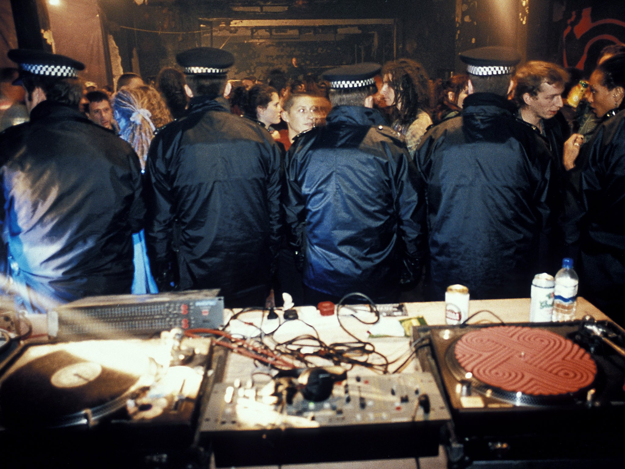 Police stand guard over the decks after busting an illegal warehouse party