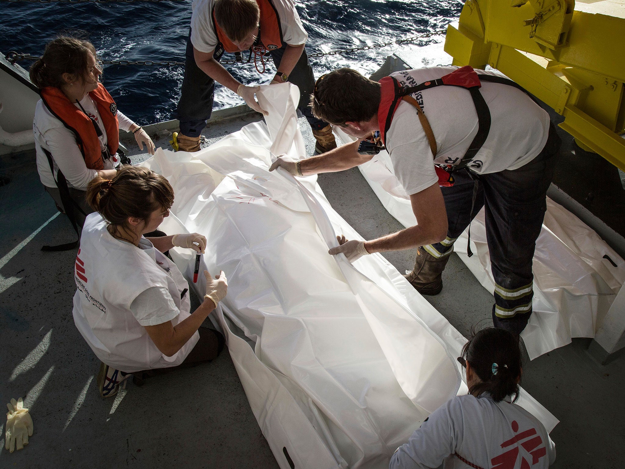 MSF staff on the Aquarius handle the body of a migrant who died on a boat crossing the Mediterranean Sea on 13 January