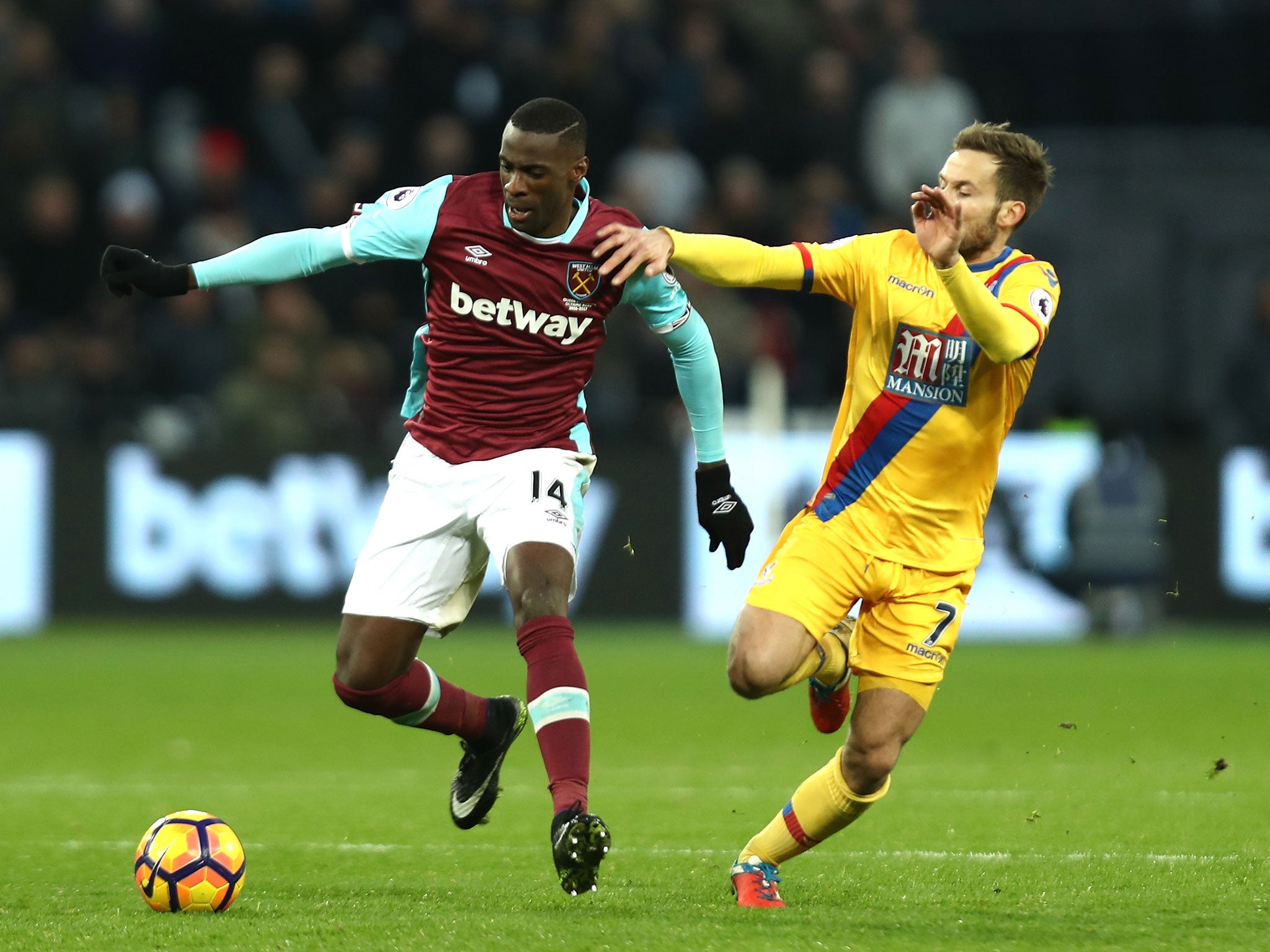 Yohan Cabaye tussles to take the ball off Pedro Obiang