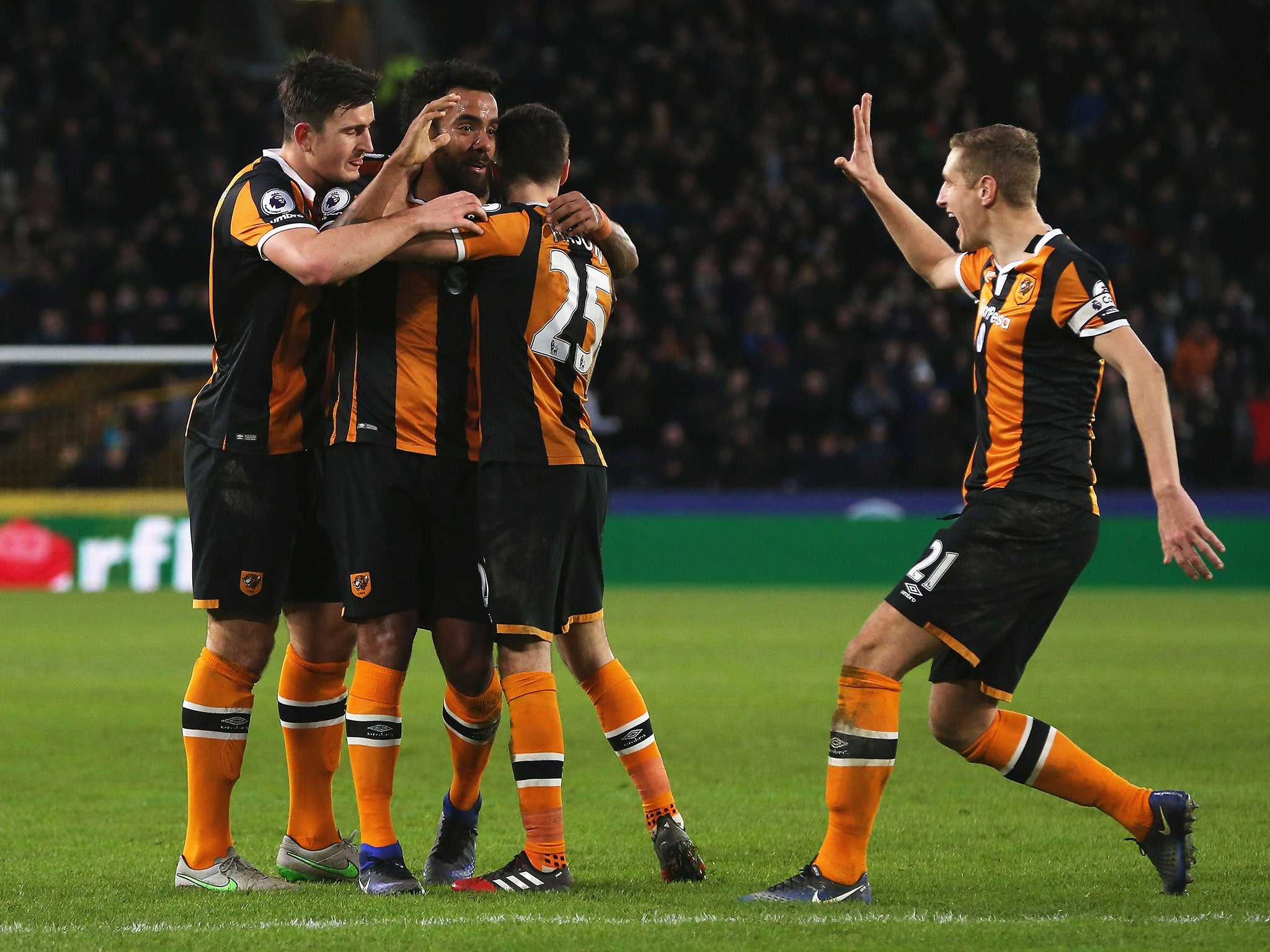 Hull players celebrate after Tom Huddlestone's effort was deflected into the Bournemouth goal by Tyrone Mings