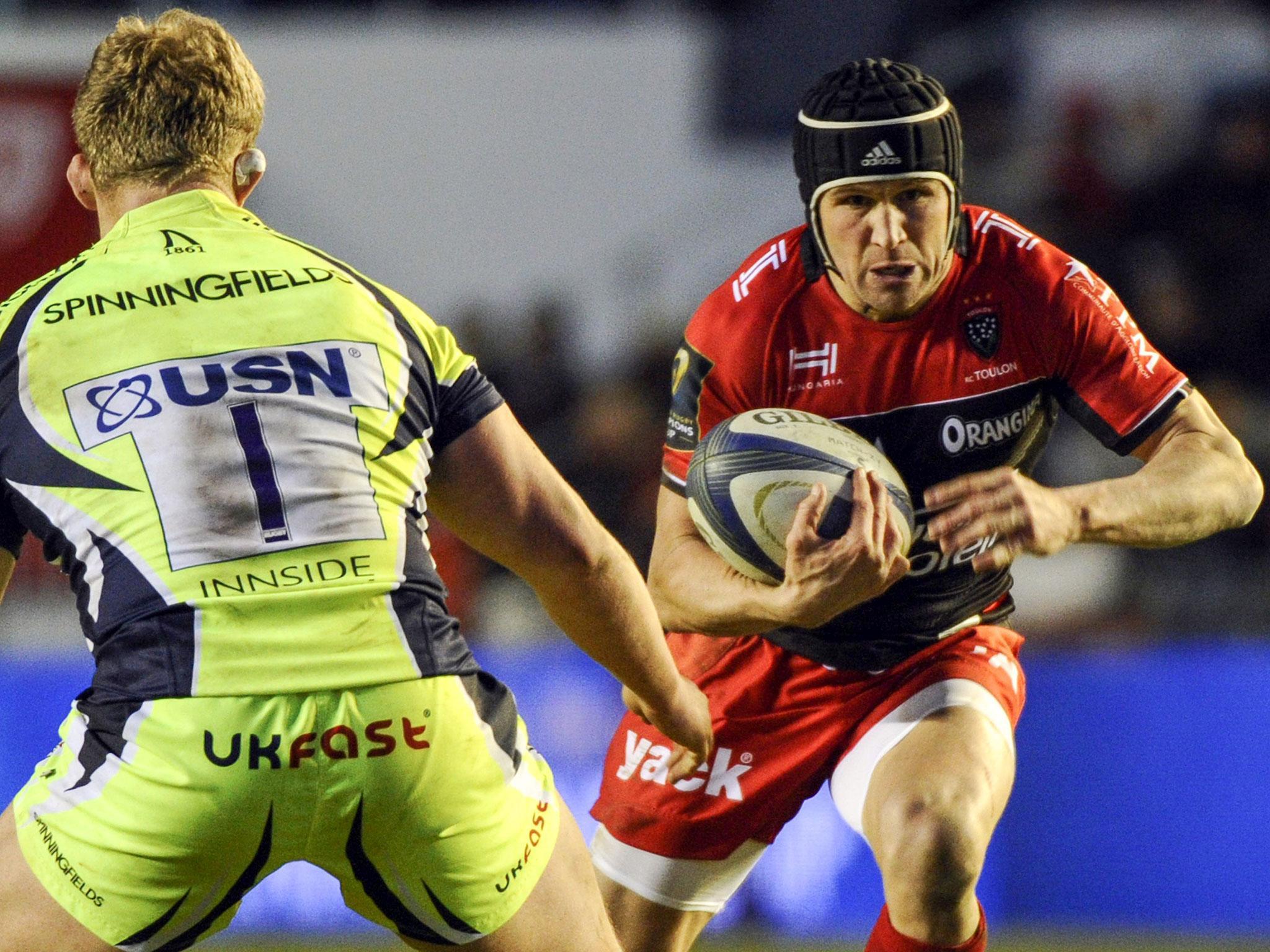 Matt Giteau runs with the ball past prop Ross Harrison