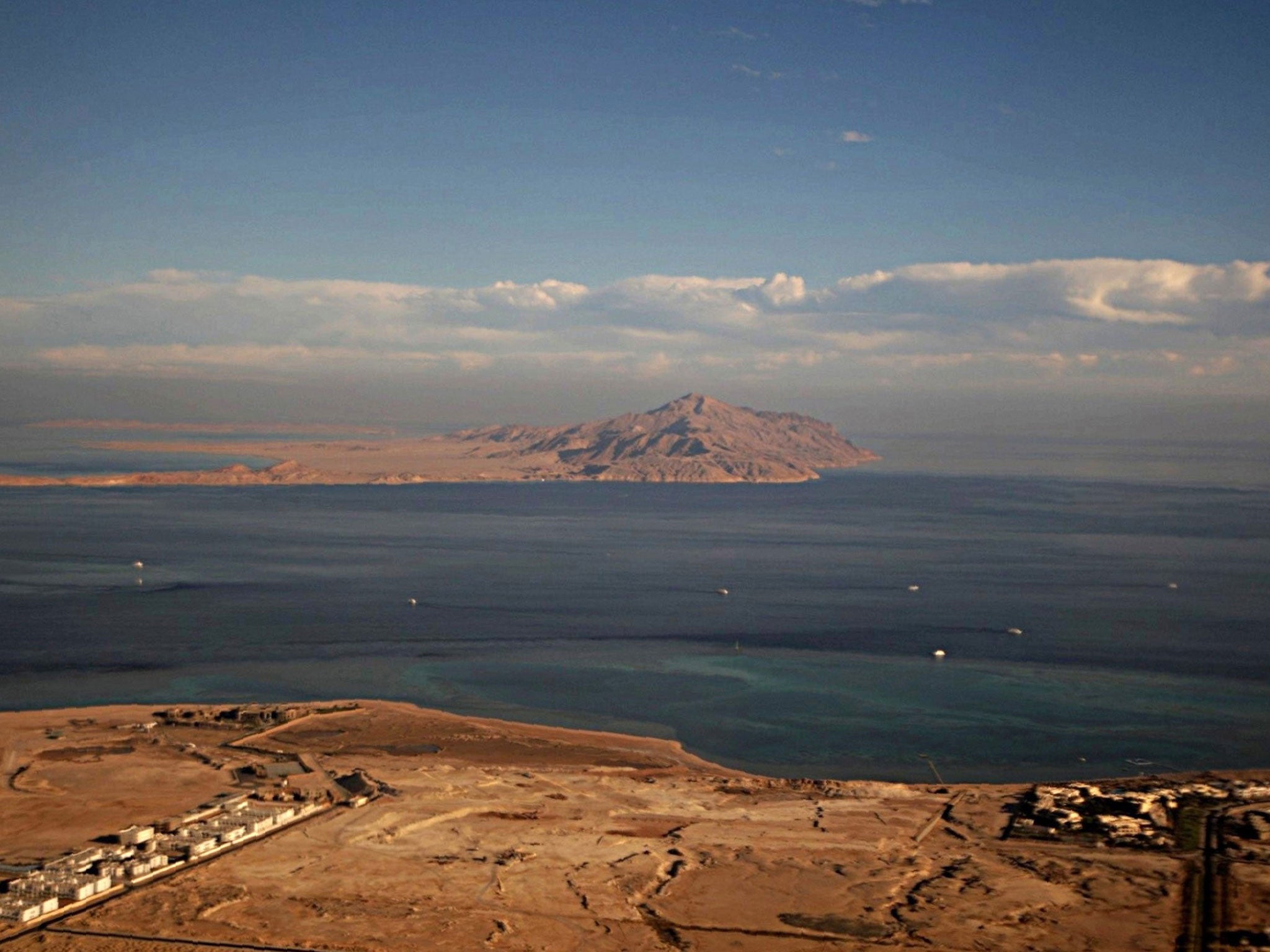 The Red Sea's Tiran (foreground) and the Sanafir (background) islands in the Strait of Tiran between Egypt's Sinai Peninsula and Saudi Arabia, seen from a plane