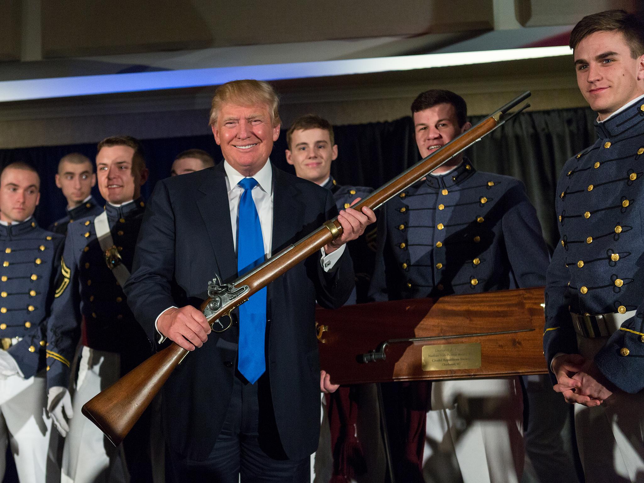 Mr Trump holds The Nathan Hale patriot award given him during the Republican Society Patriot Dinner at the Citadel Military College on 22 February, 2015. The musket is now on his wall.