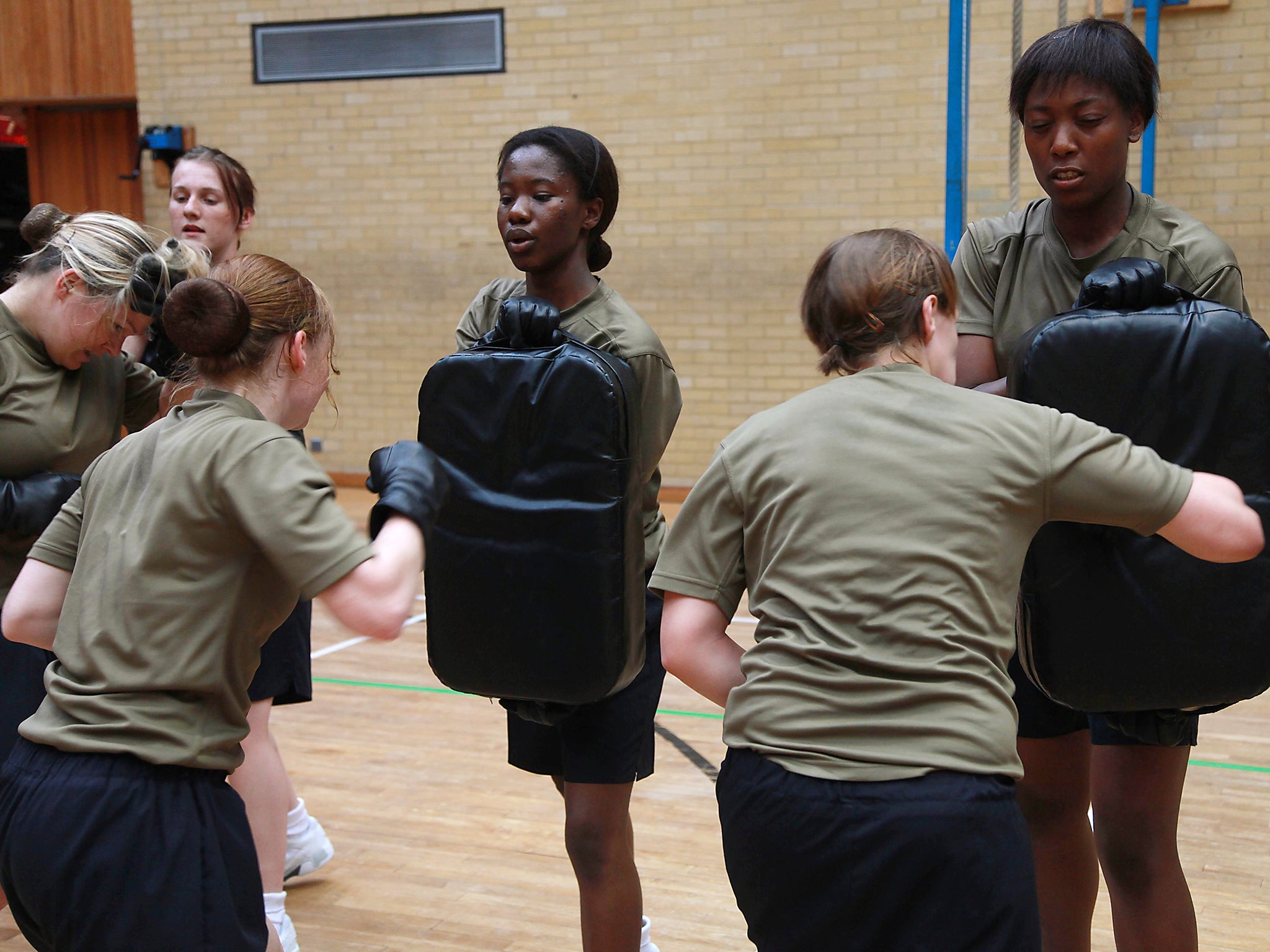 Recruits at the Army training centre in Pirbright, Surrey – many get a taste for military life at school