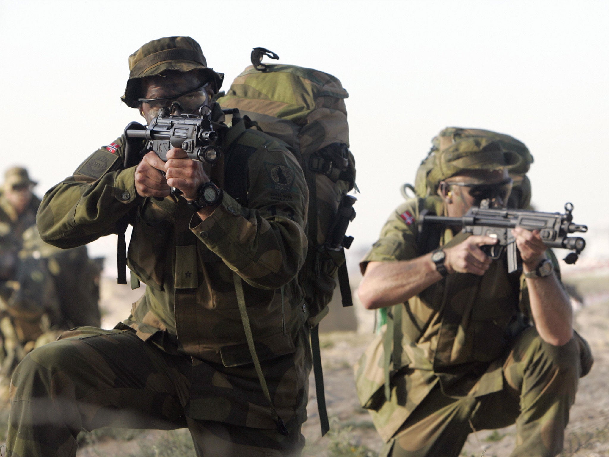 Norwegian soldiers take aim with their sub-machine guns during a drill