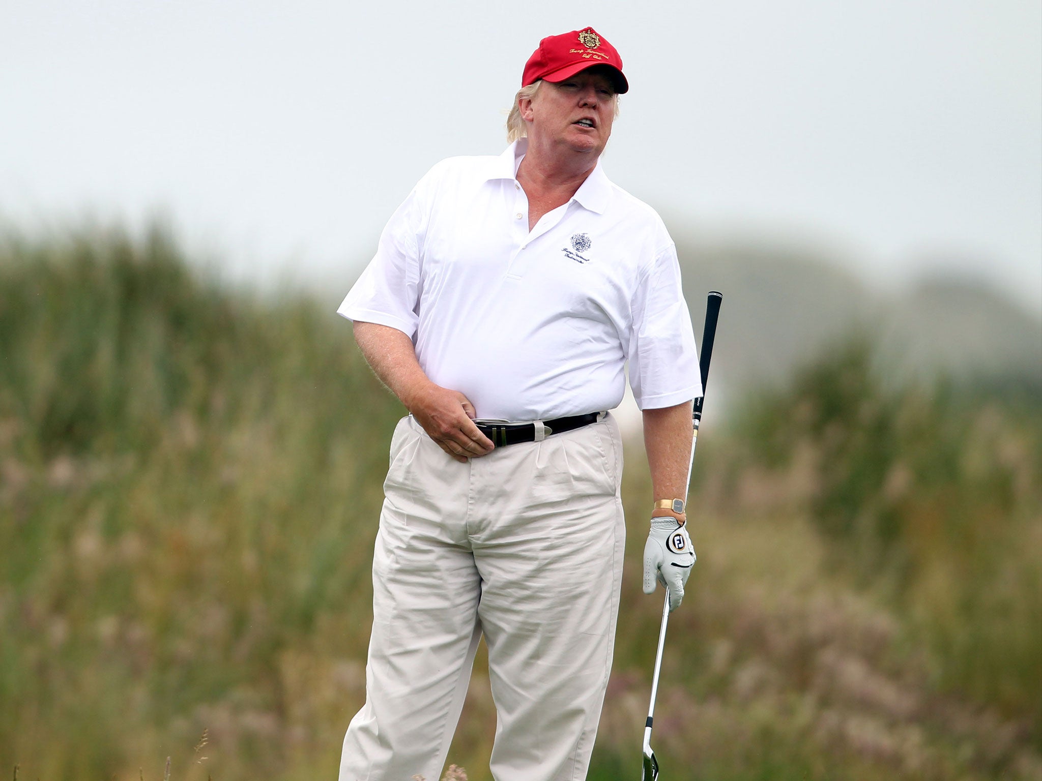 Donald Trump plays a round of golf after the opening of his Scottish course