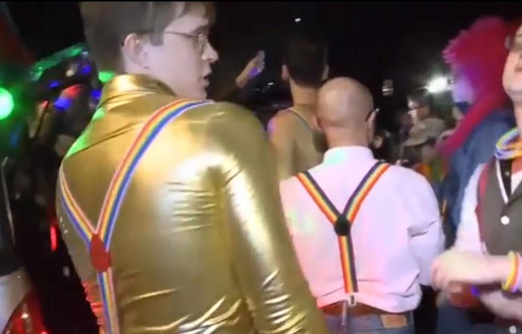 Activists wore rainbow flag suspenders as they danced