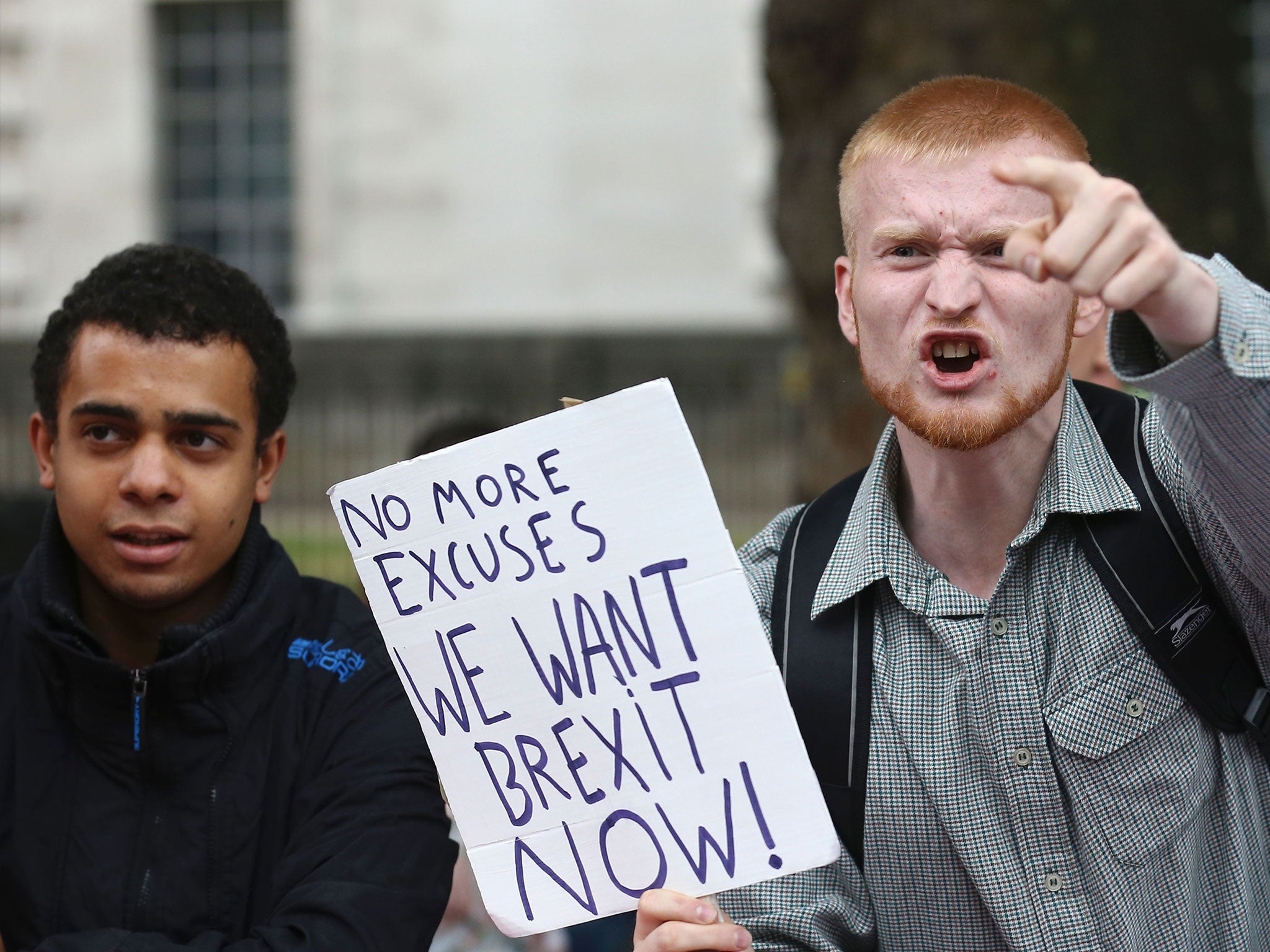 A man carrying an anti-EU placard shouts at pro-Europe marchers in London on 3 September 2016