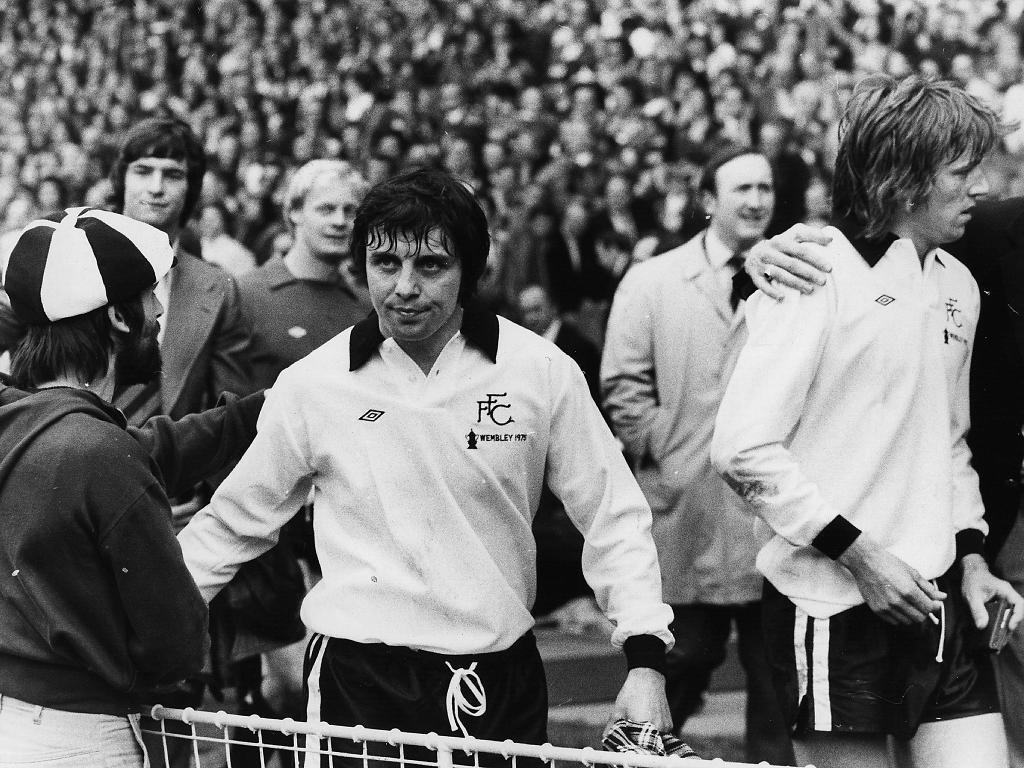 Jimmy Conway (left) and John Mitchell, two dejected Fulham players leave the pitch at Wembley after being beaten 2-0 in the FA Cup Final against West Ham United