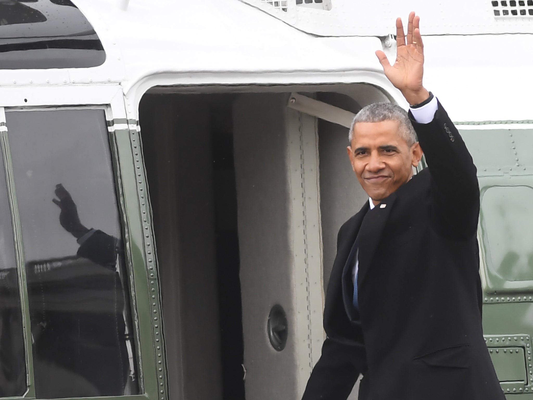 Barack Obama climbs aboard Marine One en route to Joint Base Andrews