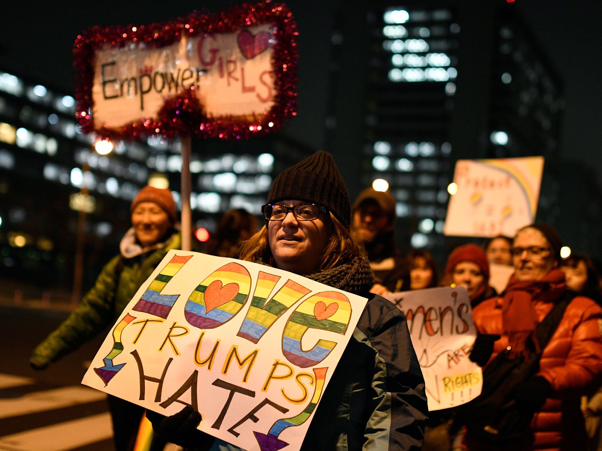 A woman holds a banner during a march to thank outgoing President Barack Obama and reject US President-elect Donald Trump before his inauguration at a park in Tokyo, Japan, 20 January 2017.