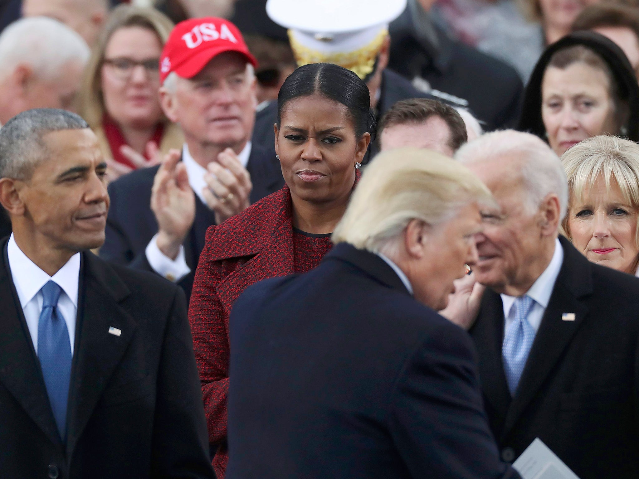 U.S. President Donald Trump shakes hands with outgoing U.S. Vice President Joe Biden as outgoing President Barack Obama and Michelle Obama look on