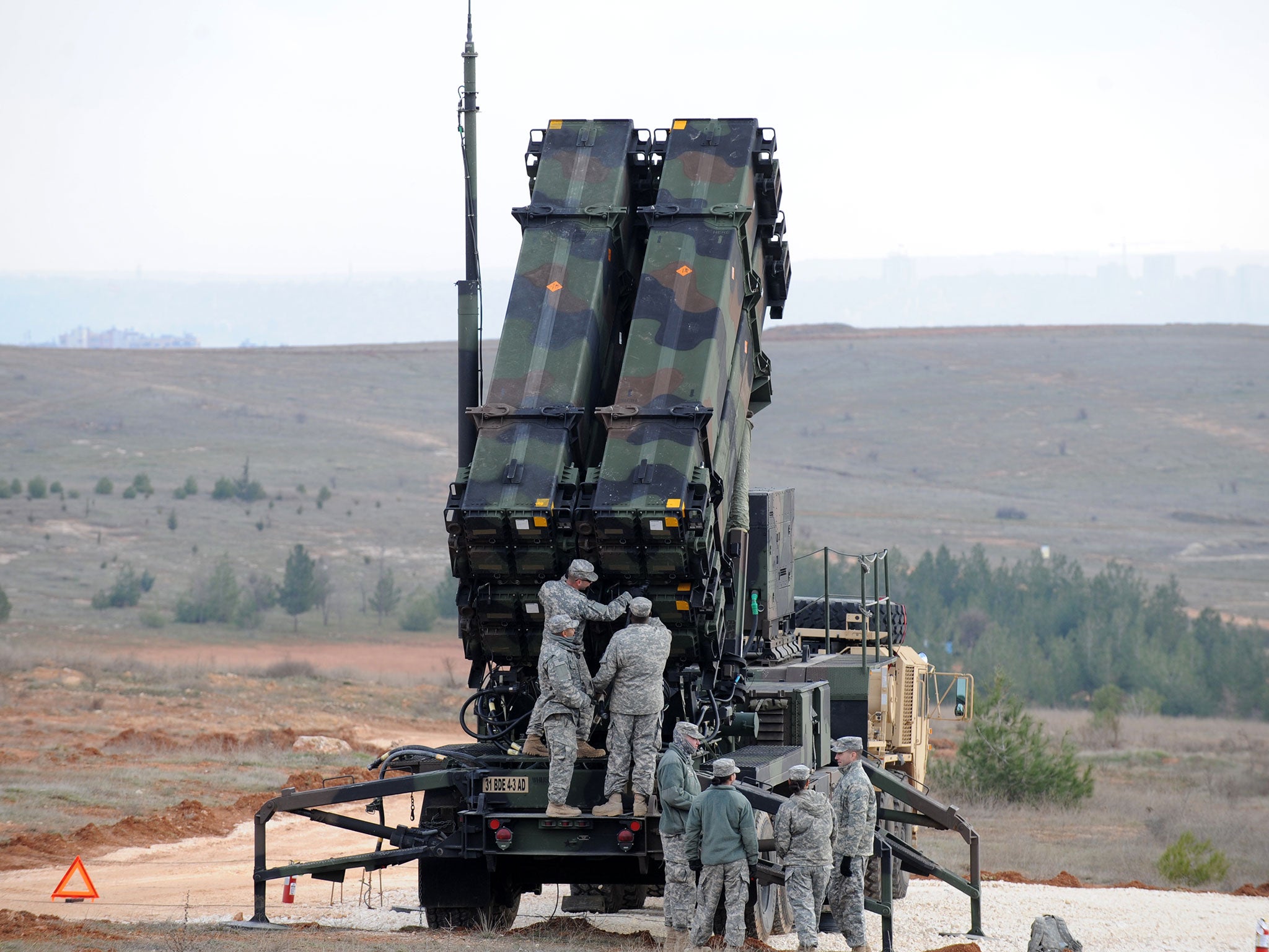 Soldiers work on a Patriot missile system, used around the world by the US military