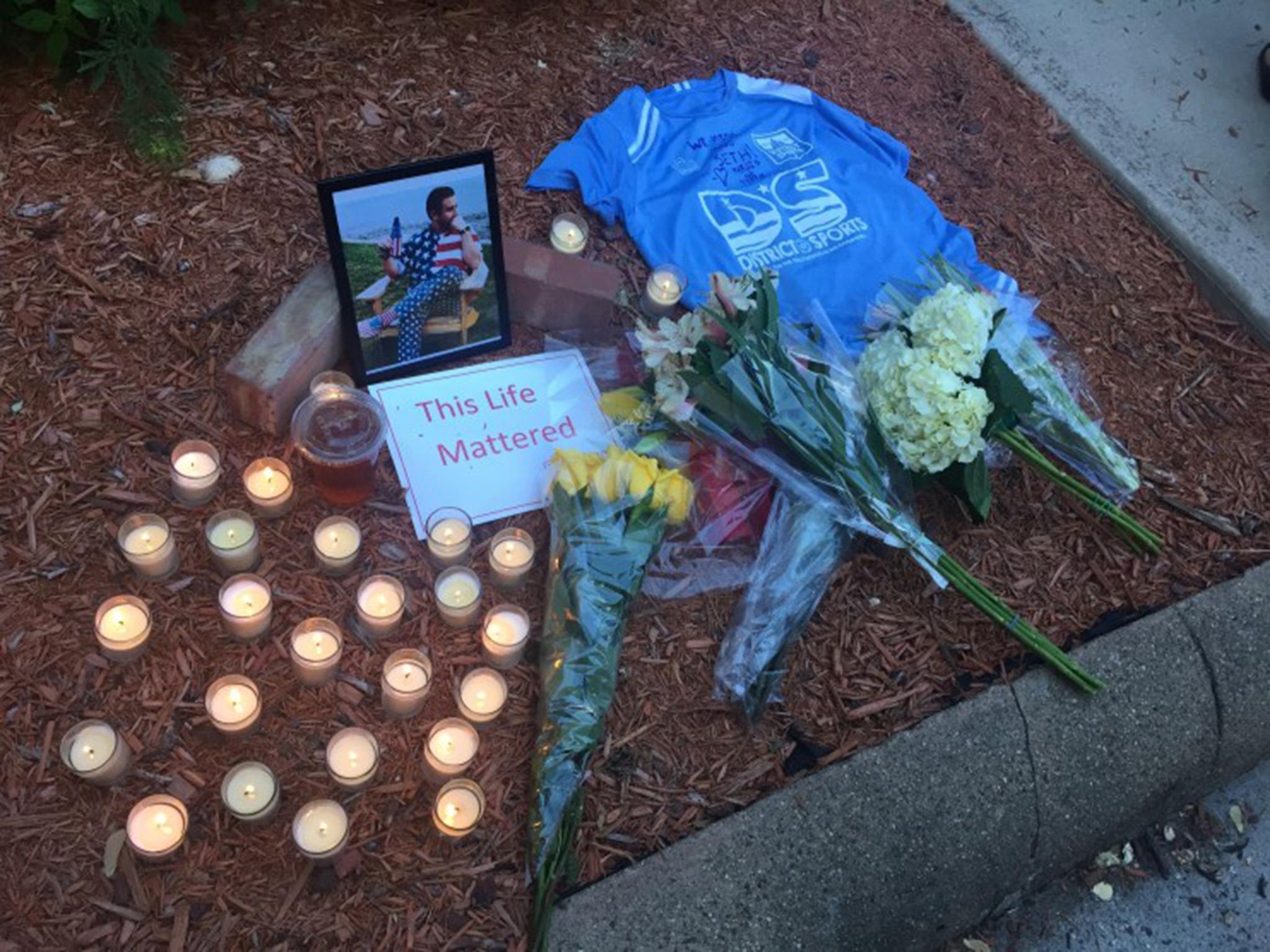 Candles, flowers and photo of Rich left in tribute to him in near where he was killed