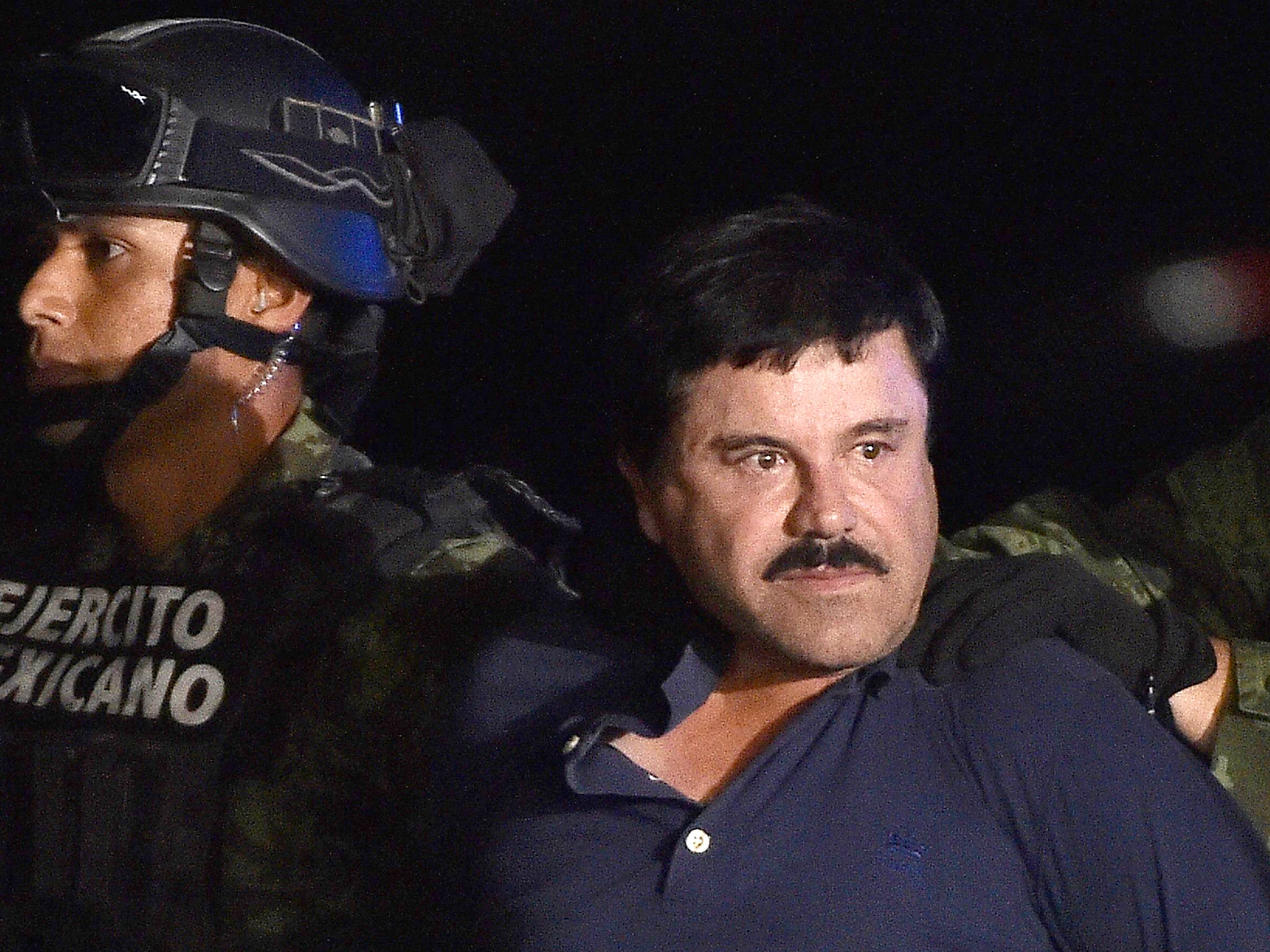 Guzman is escorted into a helicopter at Mexico City's airport following his recapture