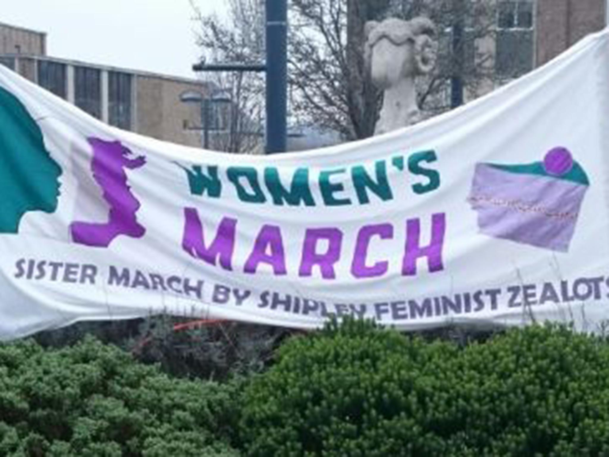 A banner advertising the march organised by Shipley Feminist Zealots in the town centre