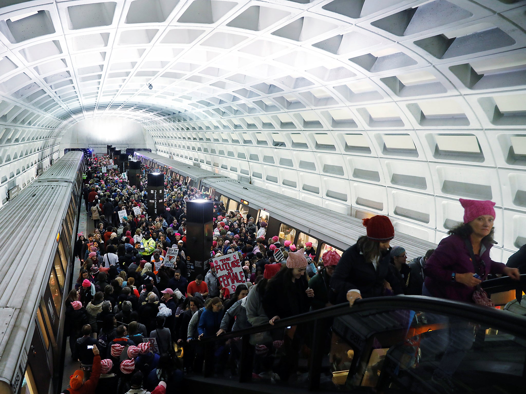 Demonstrators arrive via public transportation to take part in a 'Women's March' to protest the inauguration of Donald Trump