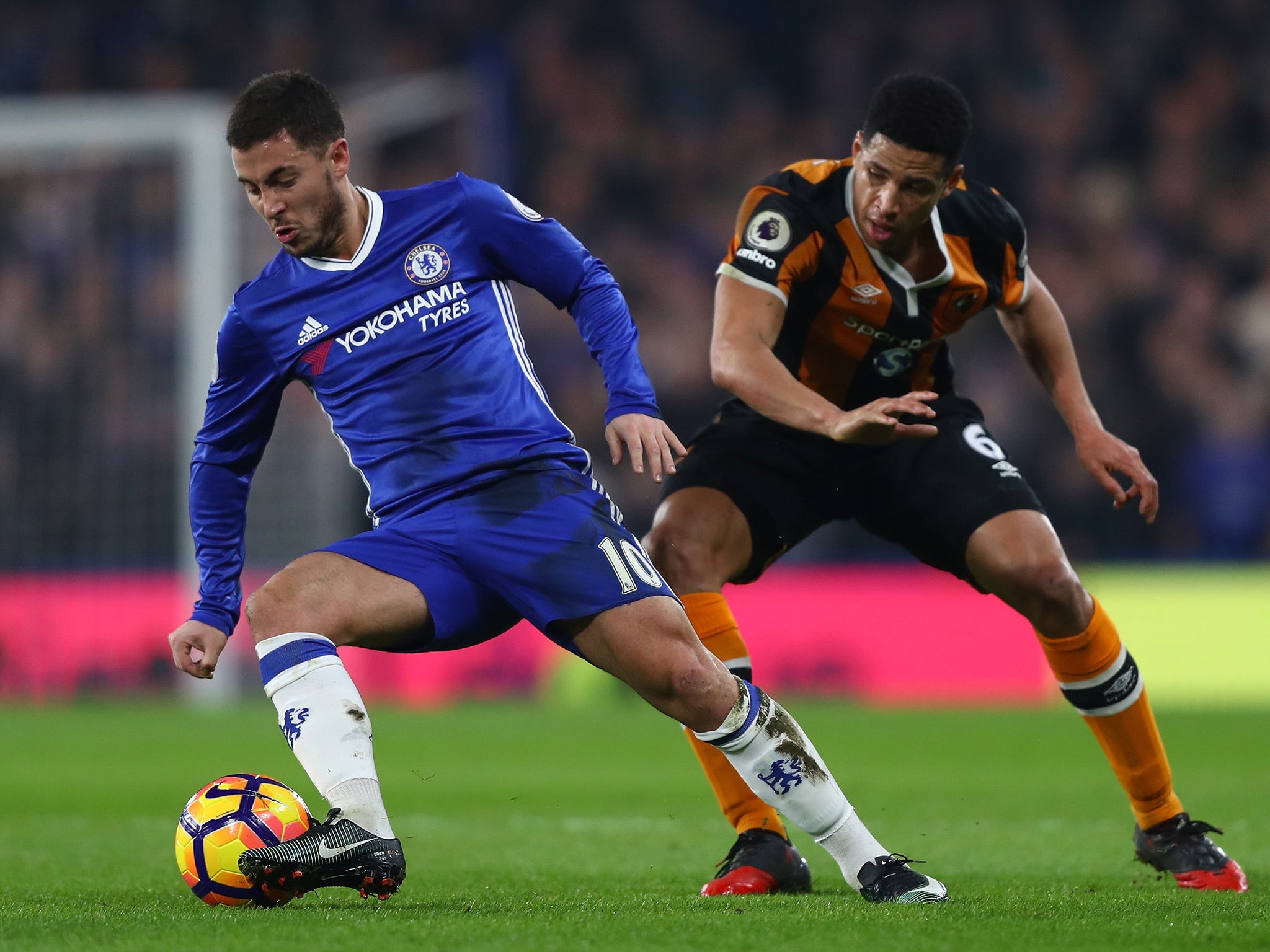 Eden Hazard jinks around Curtis Davies to spin on the attack at Stamford Bridge