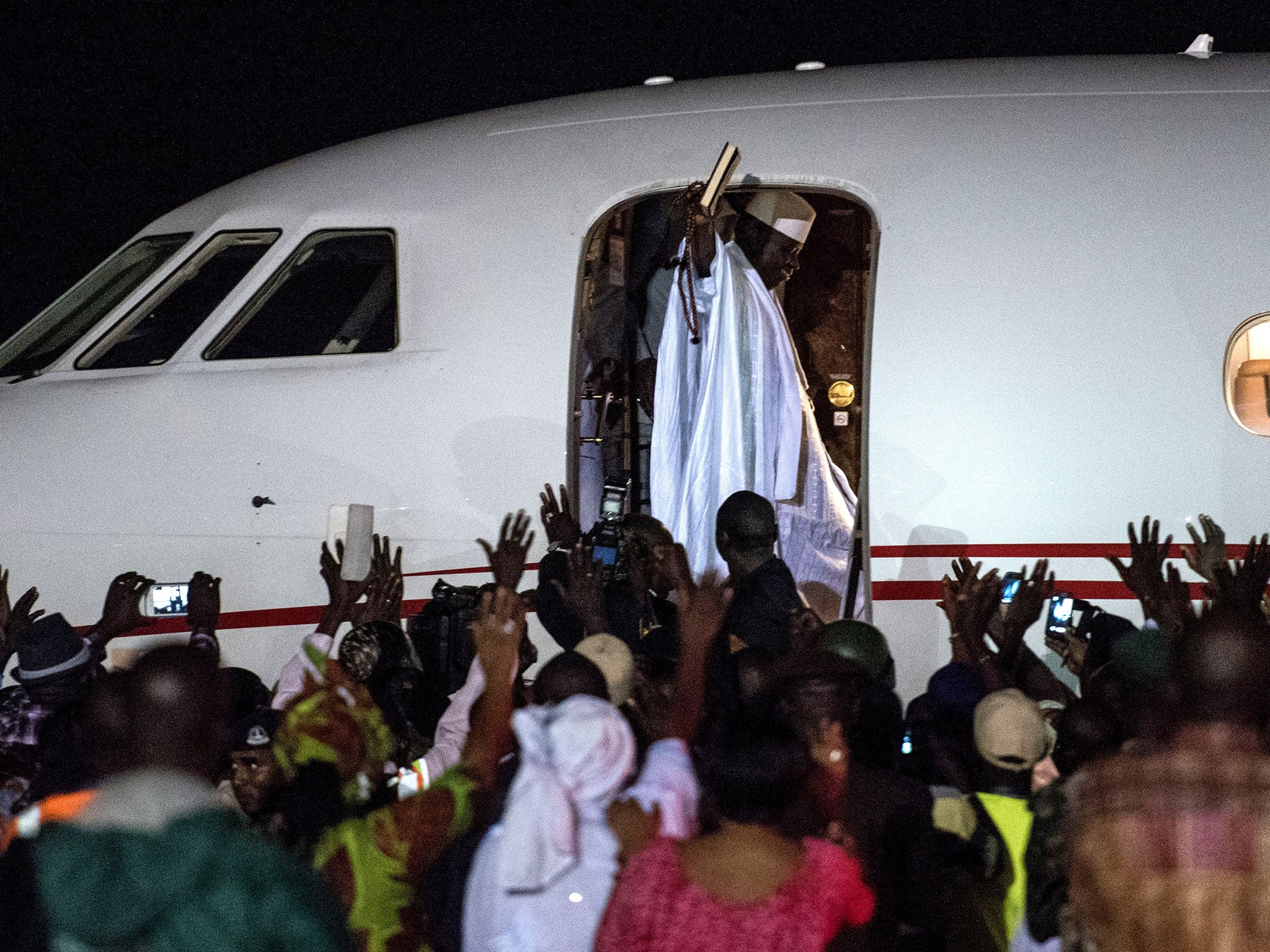 Ex-President Yahya Jammeh waves to a crowd of supporters before leaving the country on 21 January, 2017