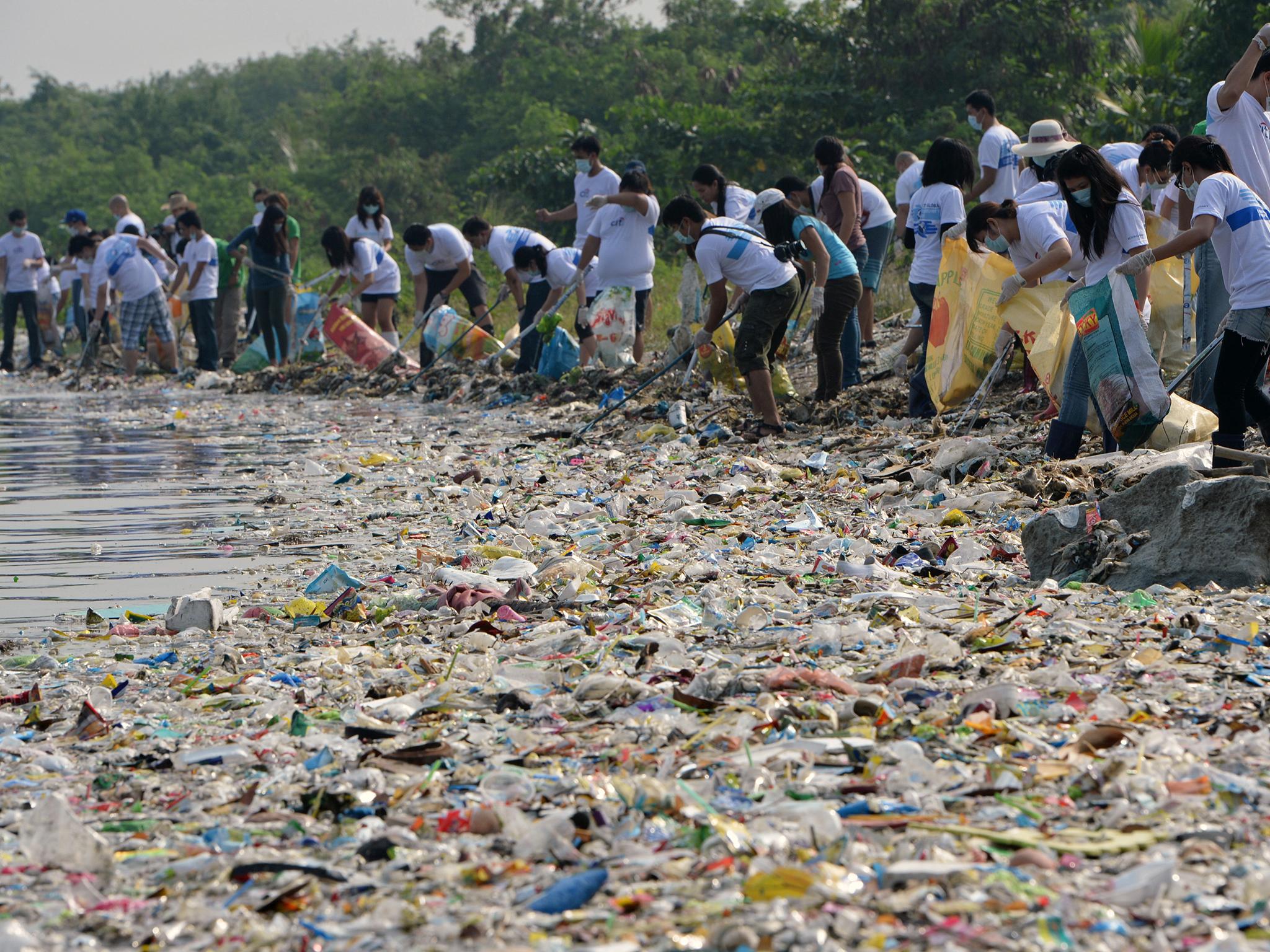 Volunteers are called in to deal with the huge volumes of rubbish along the coastline of Freedom Island in Paranaque City, suburban Manila