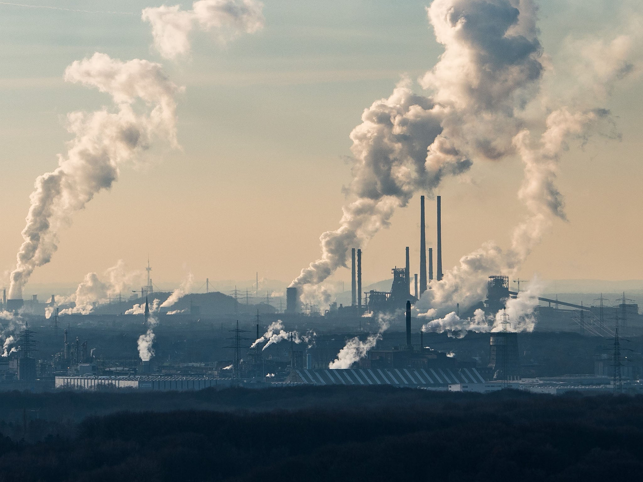 Steam and exhaust rise from the chemical company Oxea and the coking plant KBS Kokereibetriebsgesellschaft Schwelgern GmbH on a cold winter day