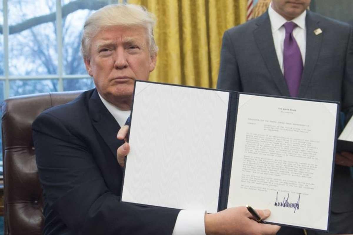 Donald Trump signing an executive order on his first full business day in office