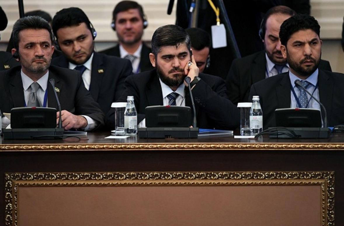 Chief opposition negotiator Mohammad Alloush (C) of the Jaish al-Islam (Army of Islam) rebel group attends the first session of Syria peace talks at Astana's Rixos President Hotel on January 23, 2017