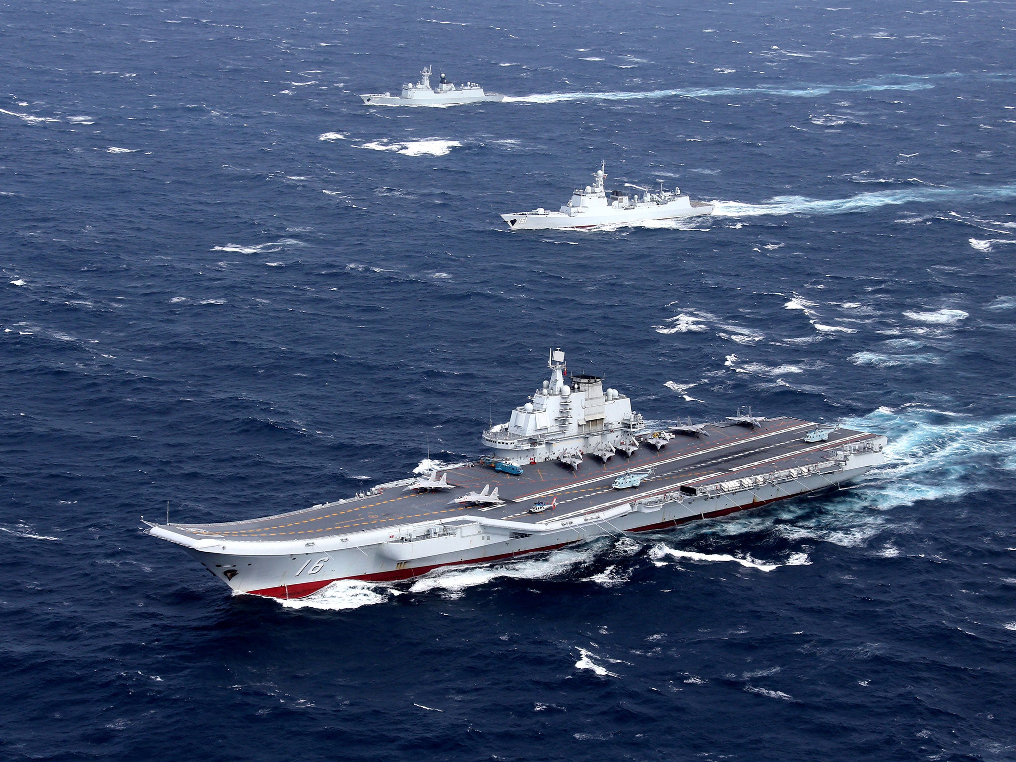 China's Liaoning aircraft carrier with accompanying fleet conducts a drill in an area of South China Sea