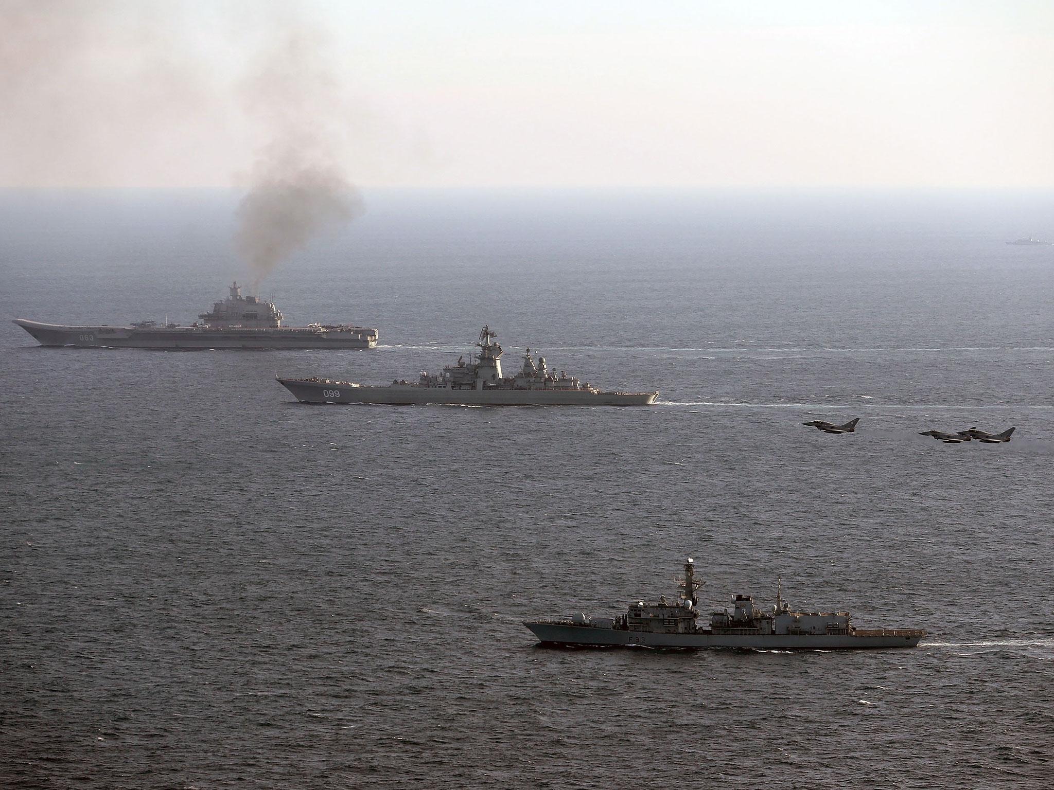 HMS St Albans (foreground), escorting Russian Warships Petr Velikiy (centre) and the Admiral Kuznetsov (background), as they pass through the English Channel on their way back to Russia