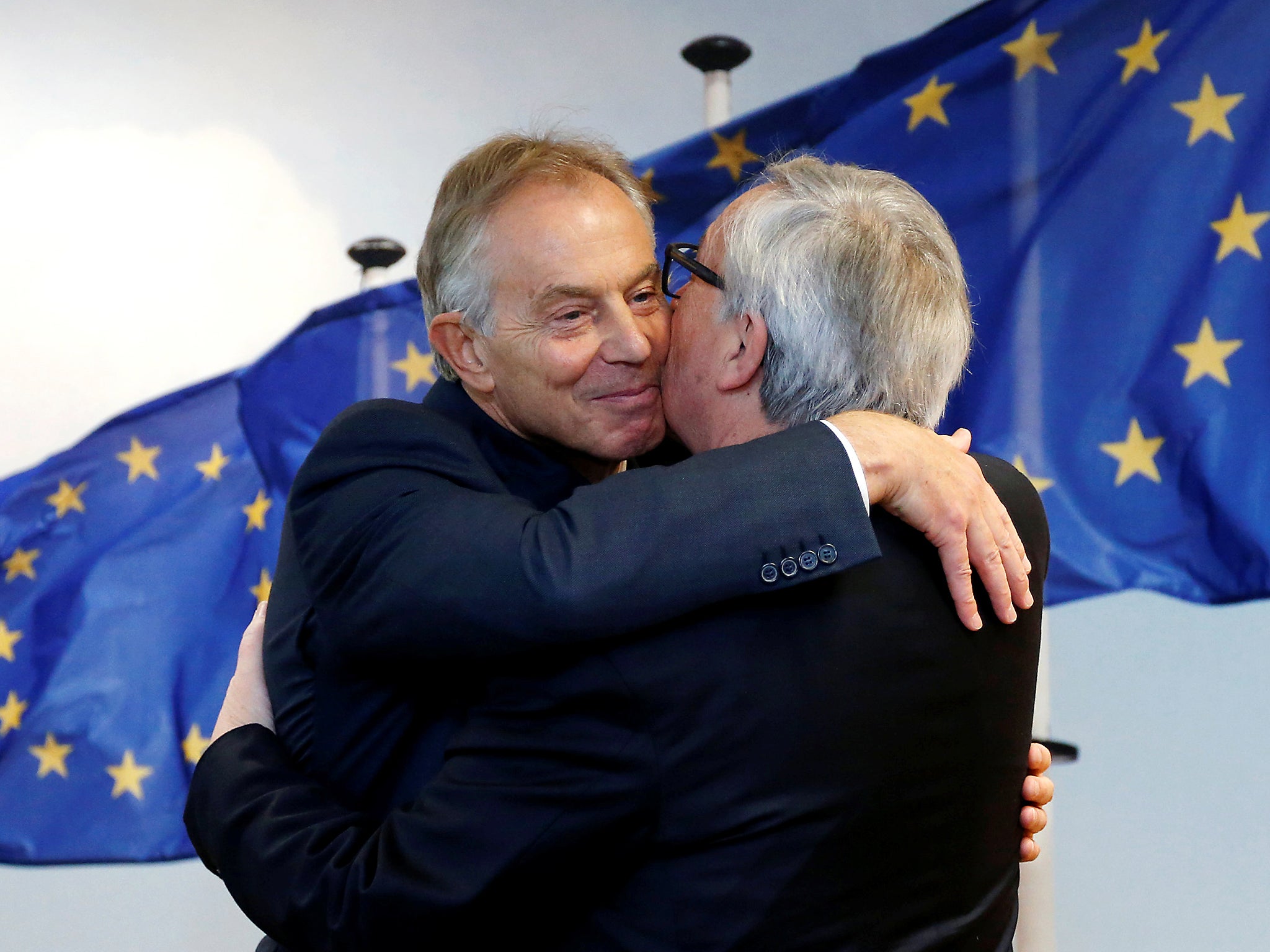 European Commission President Jean-Claude Juncker greets former British Prime Minister Tony Blair