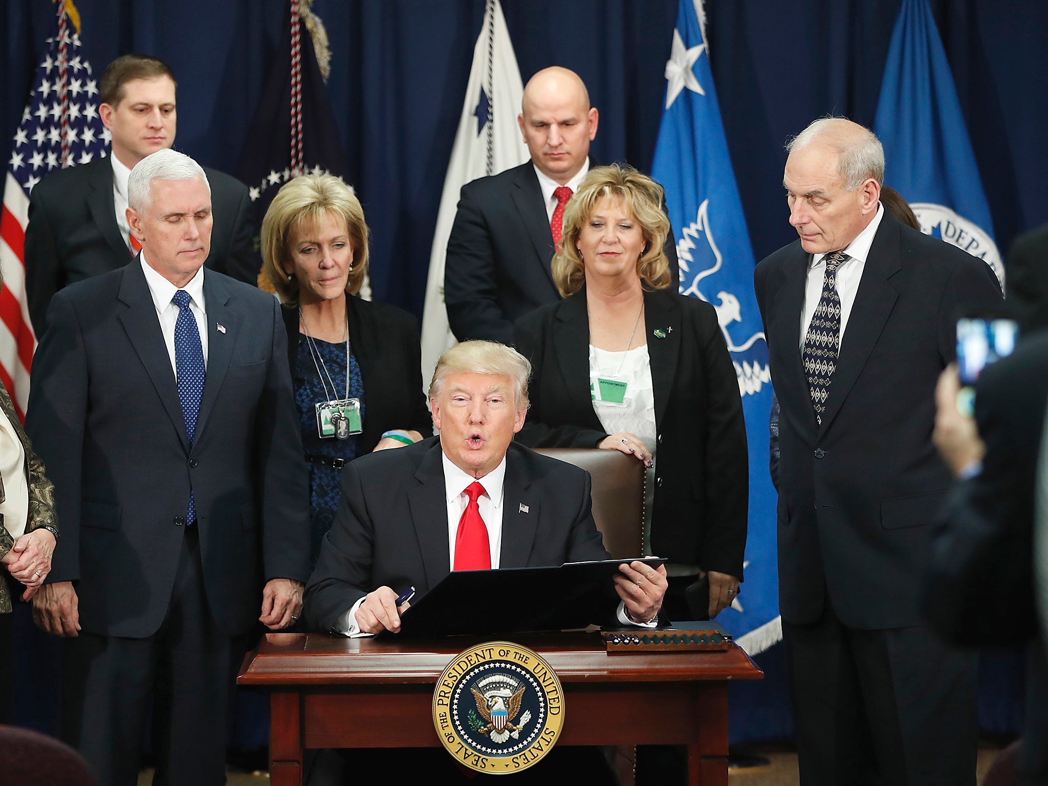 President Donald Trump, accompanied by Vice President Mike Pence, Homeland Security Secretary John F. Kelly, and others, speaks during a visit to the Homeland Security Department in Washington