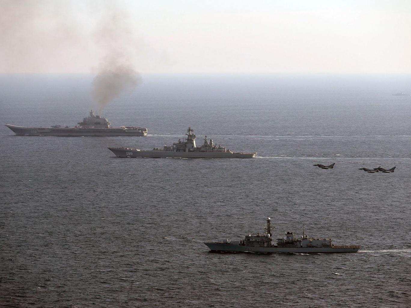 HMS St Albans (foreground), escorting Russian Warships Petr Velikiy (centre) and the Admiral Kuznetsov (background), as they pass through the English Channel on their way back to Russia