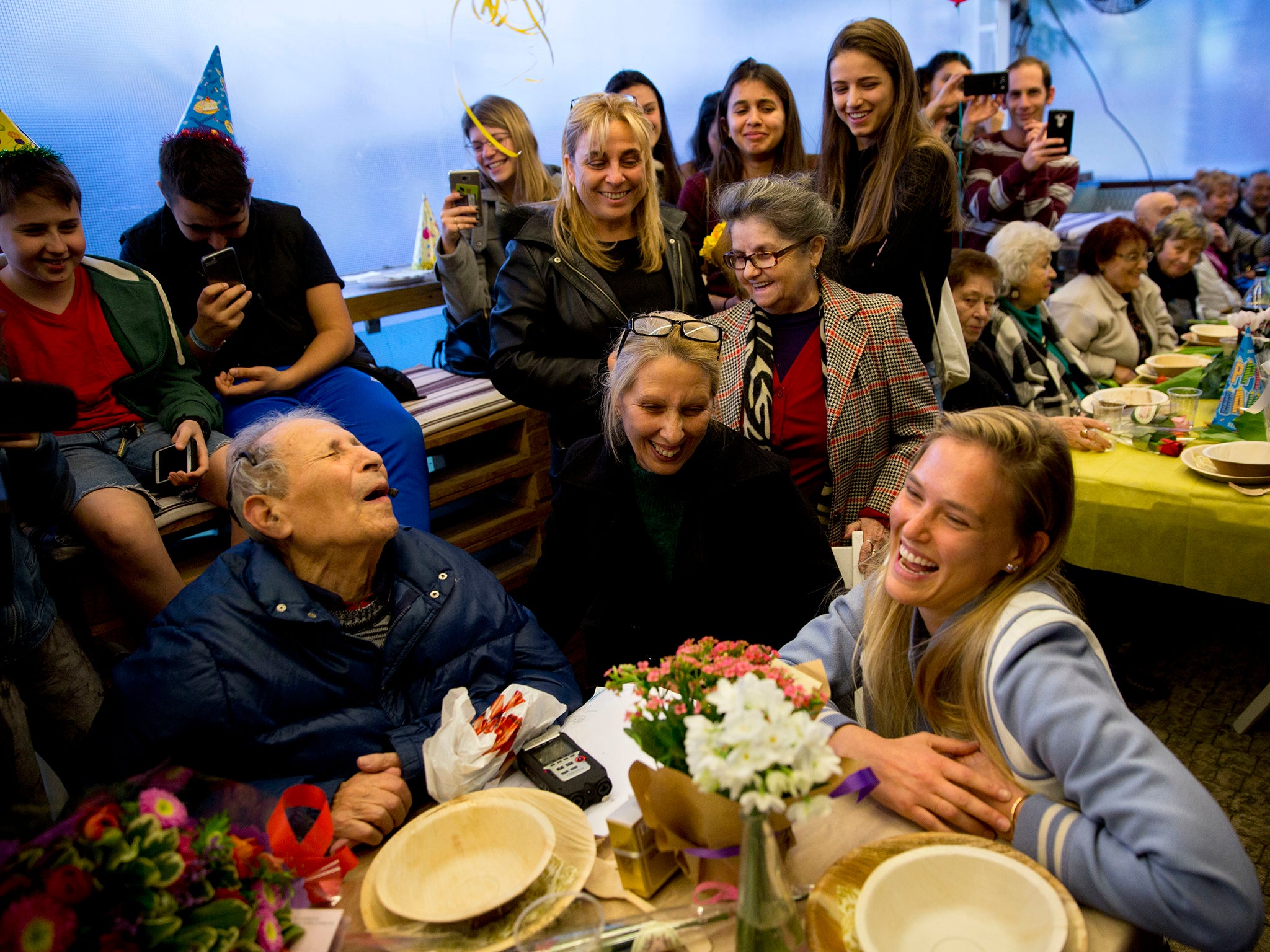 More than 100 fellow Holocaust survivors and advocates, inluding supermodel Bar Refaeli, gather for the 92nd birthday party of Ernest Weiner - a blind, disabled widower who lives alone