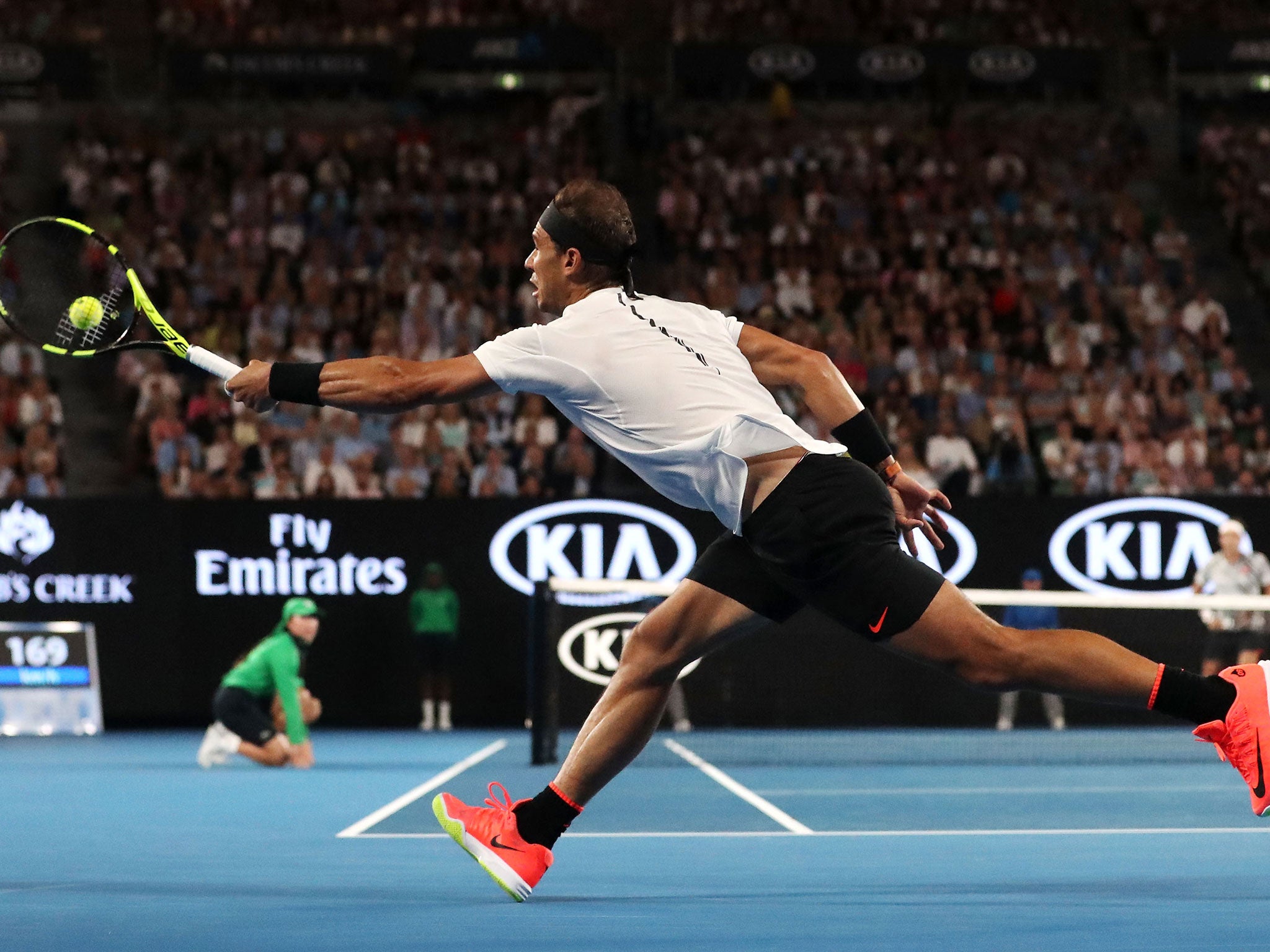 Nadal reaches to return a shot from Federer