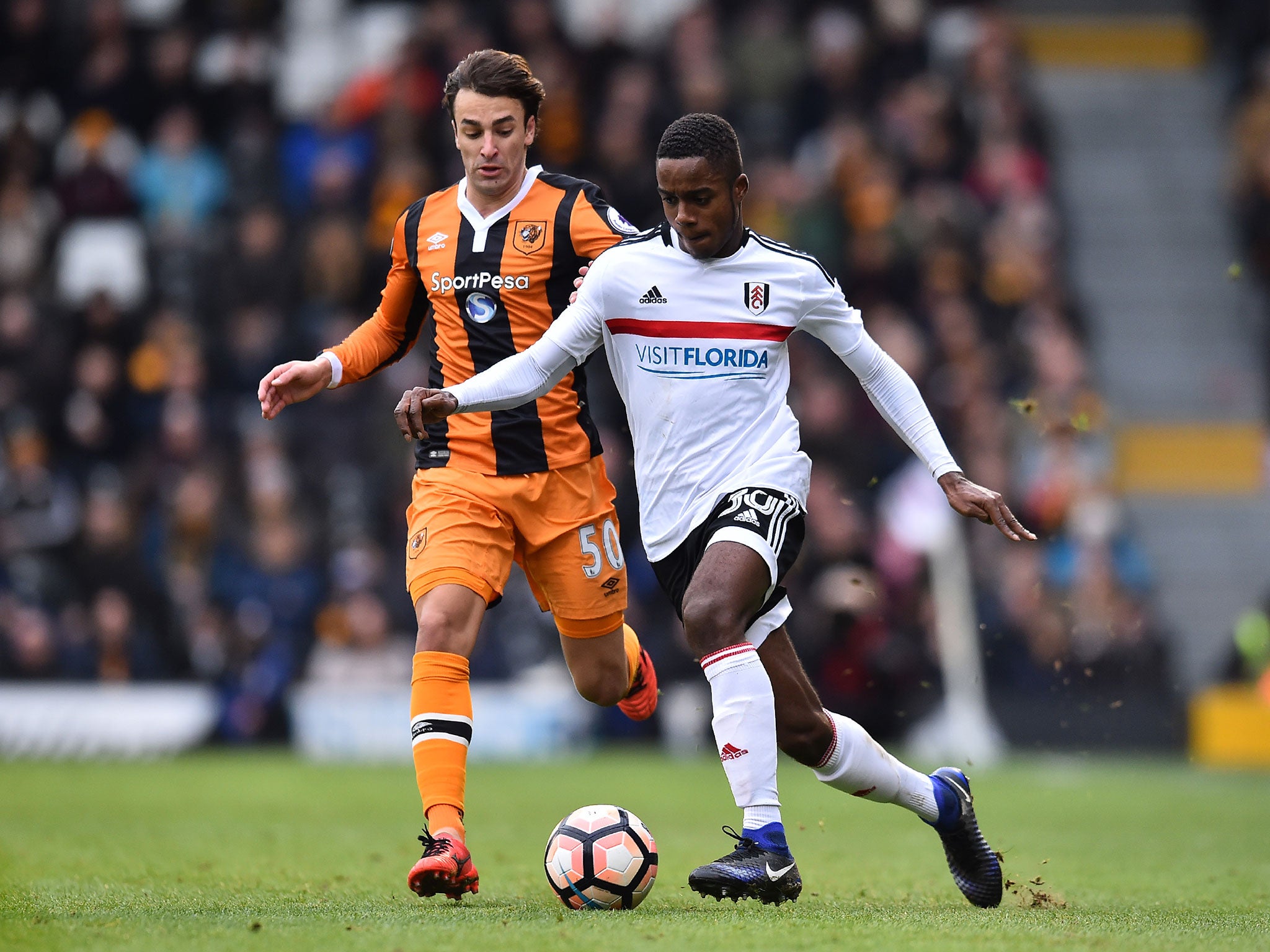 Fulham's Ryan Sessegnon takes on Hull City's Serbian midfielder Lazar Markovi