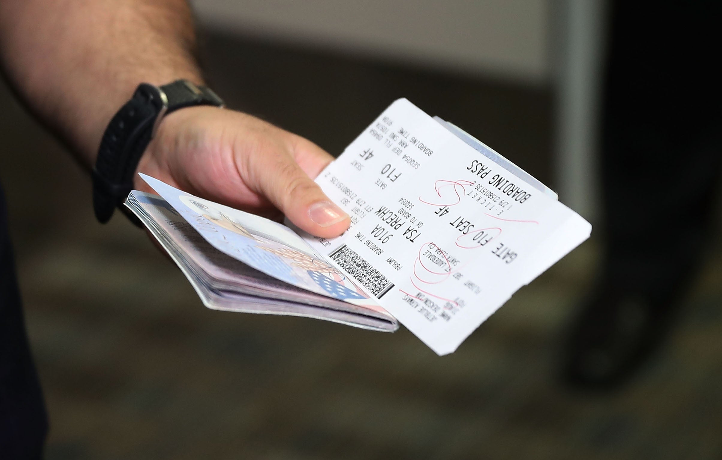 A passenger holds his passport