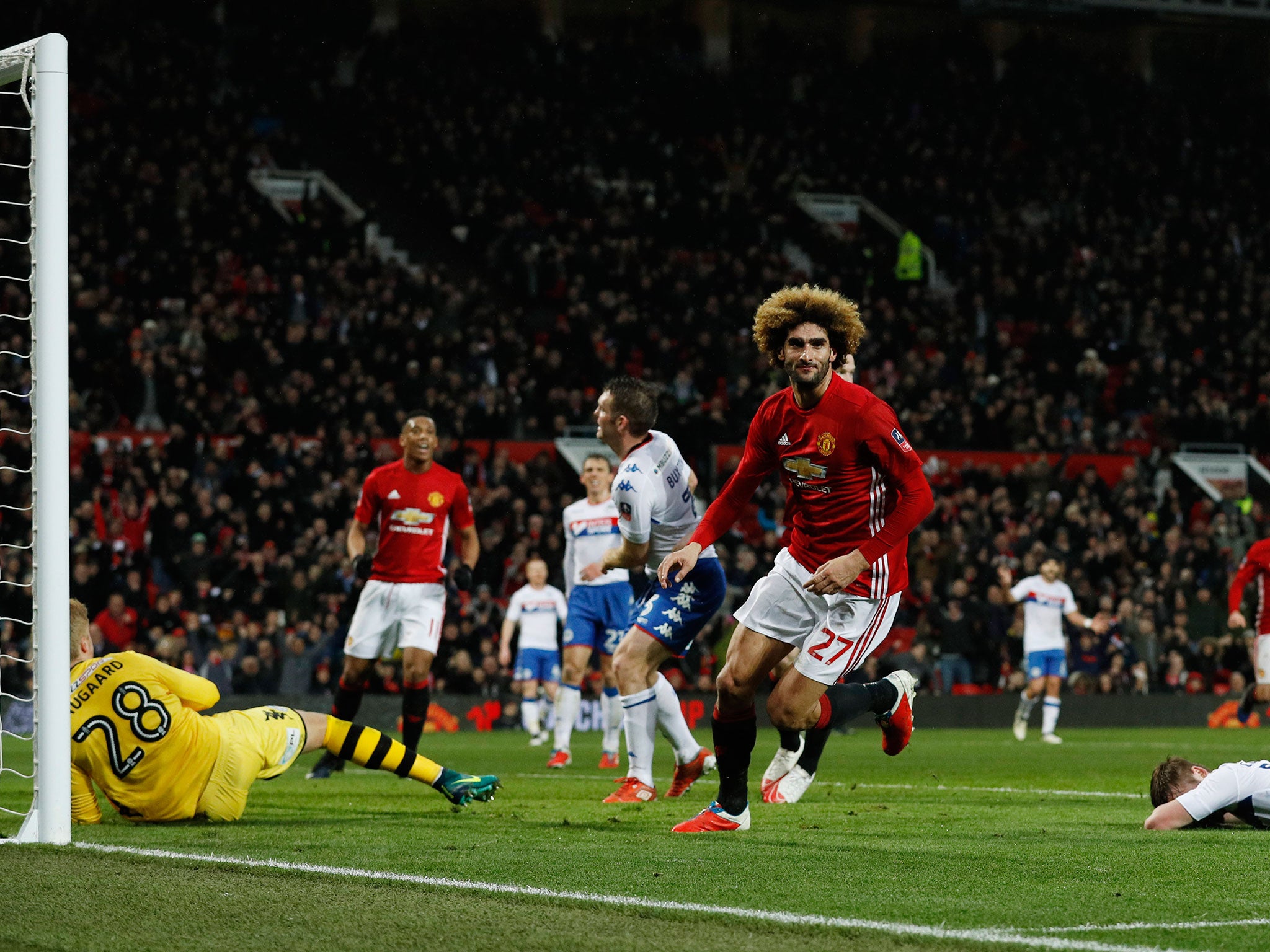 Fellaini runs off to celebrate scoring the opening goal at Old Trafford