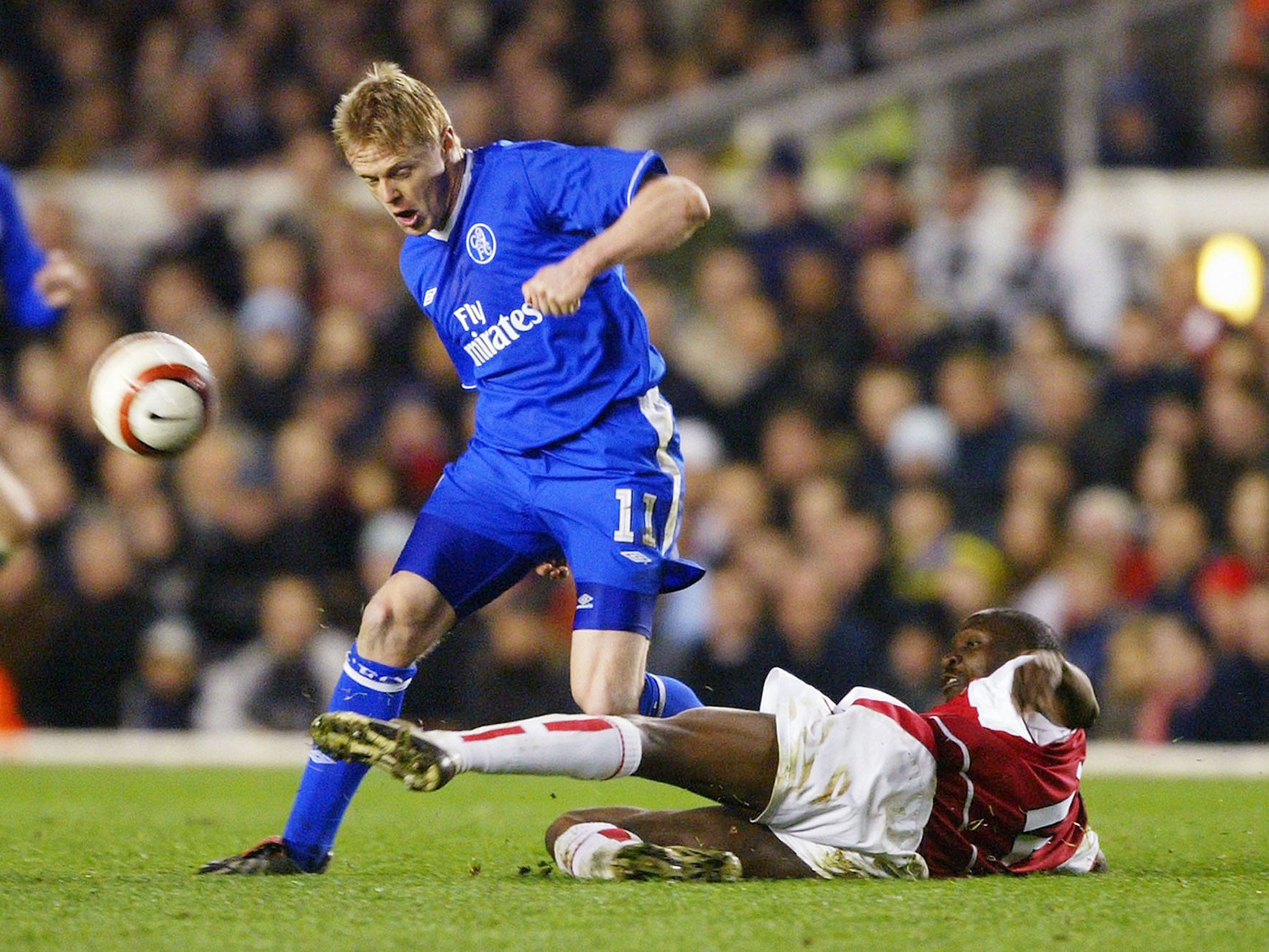 Lauren puts in a challenge on Chelsea's Damien Duff during a match between the Blues and Arsenal in March 2004